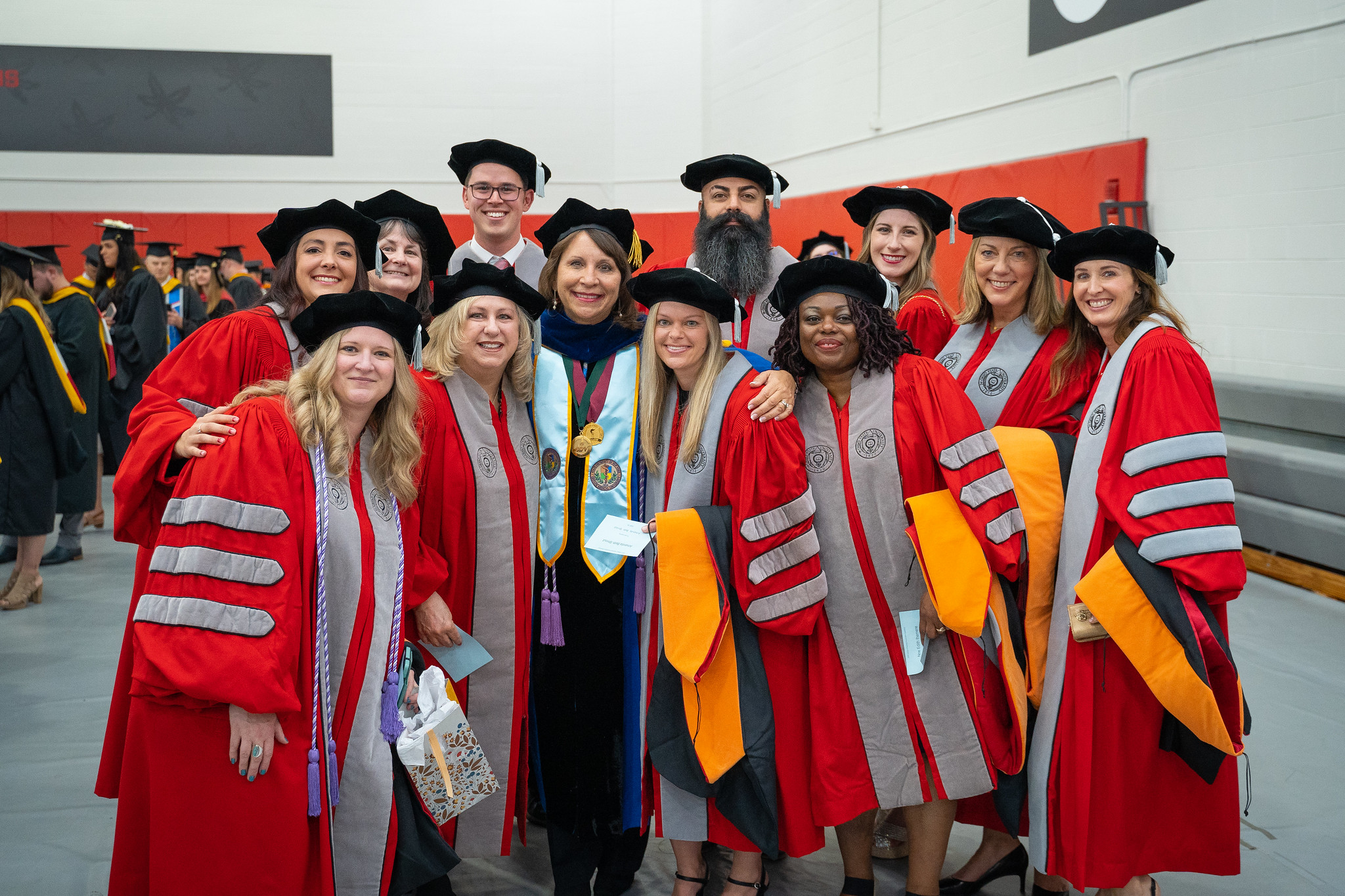 group of PhD graduates posing with Dean Melnyk before Convocation ceremony