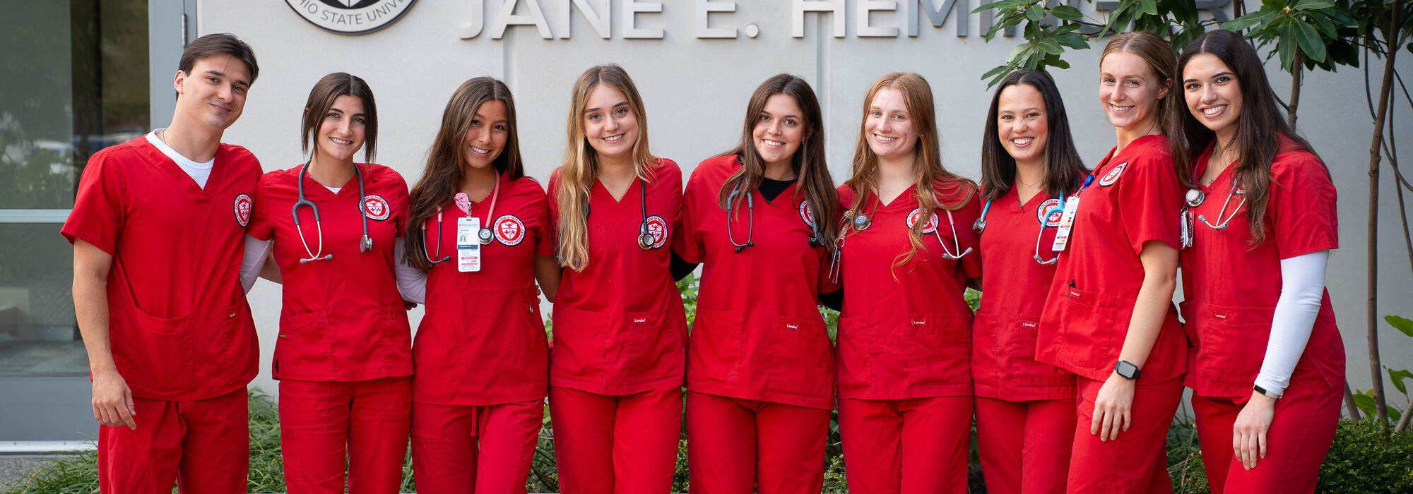 female student nurse in red scrubs