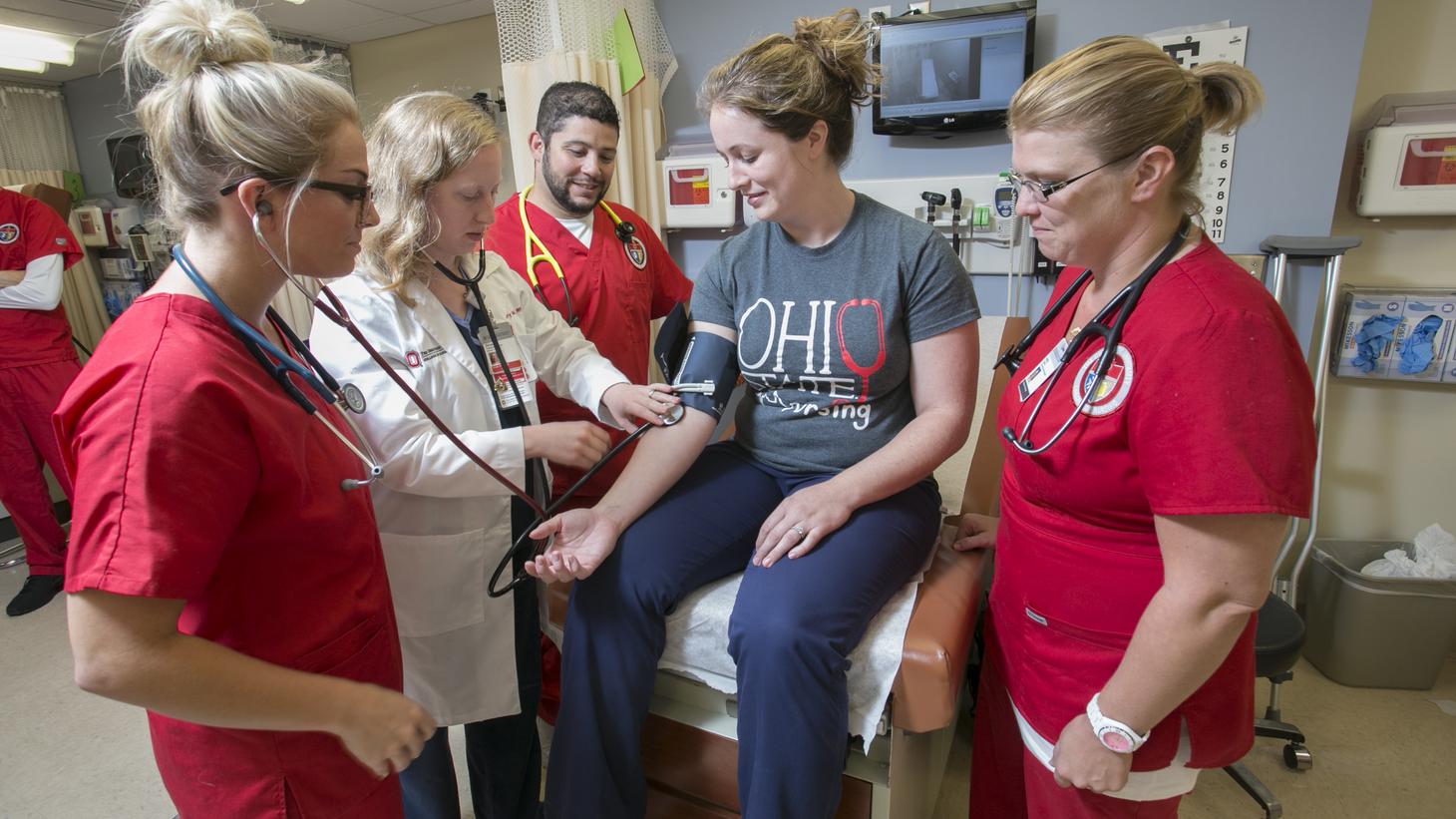 instructor showing students how to check blood pressure