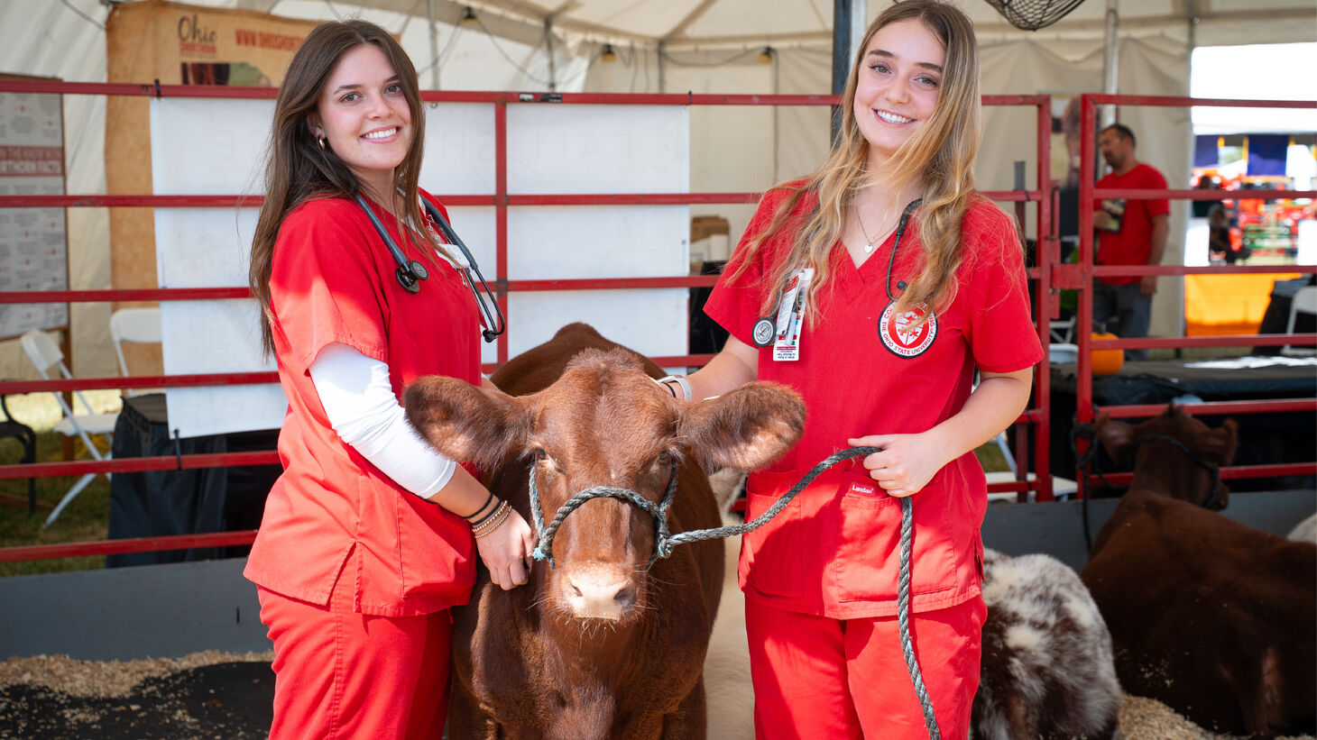 Students check blood glucose levels for Farm Science Review attendees.