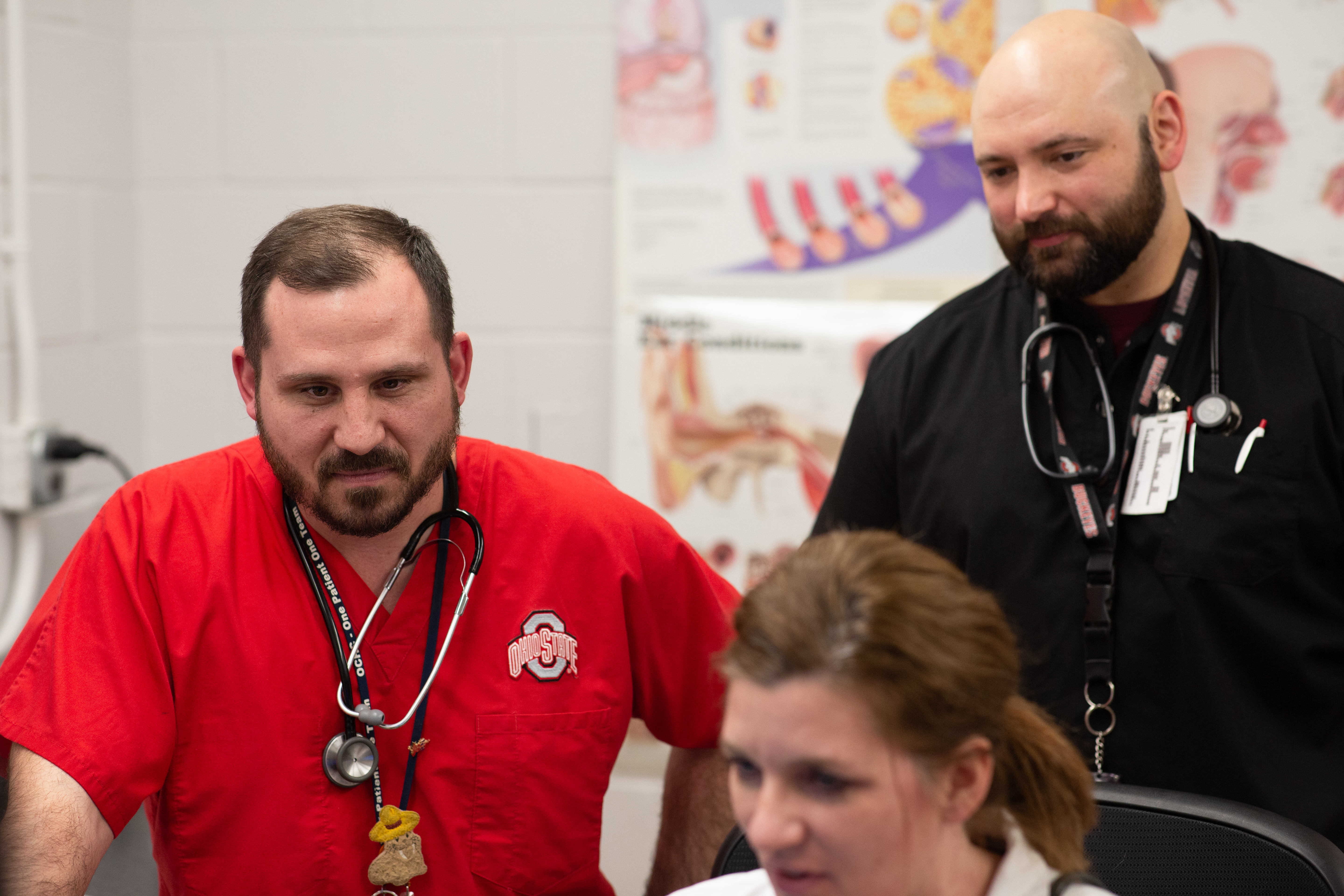 nurse in red scrub on the floor with preceptors