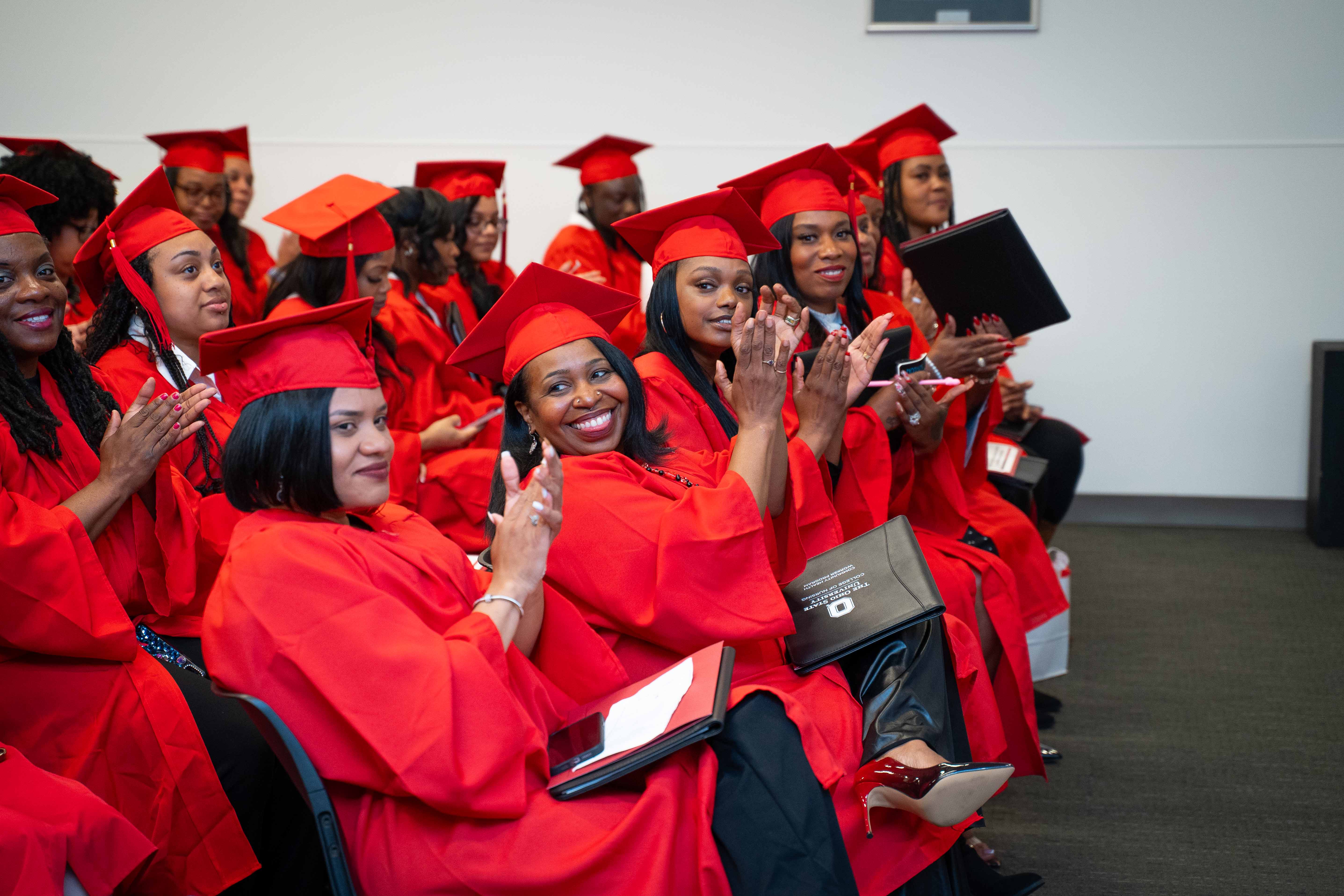 Community Health Workers in scarlet regalia at completion ceremony