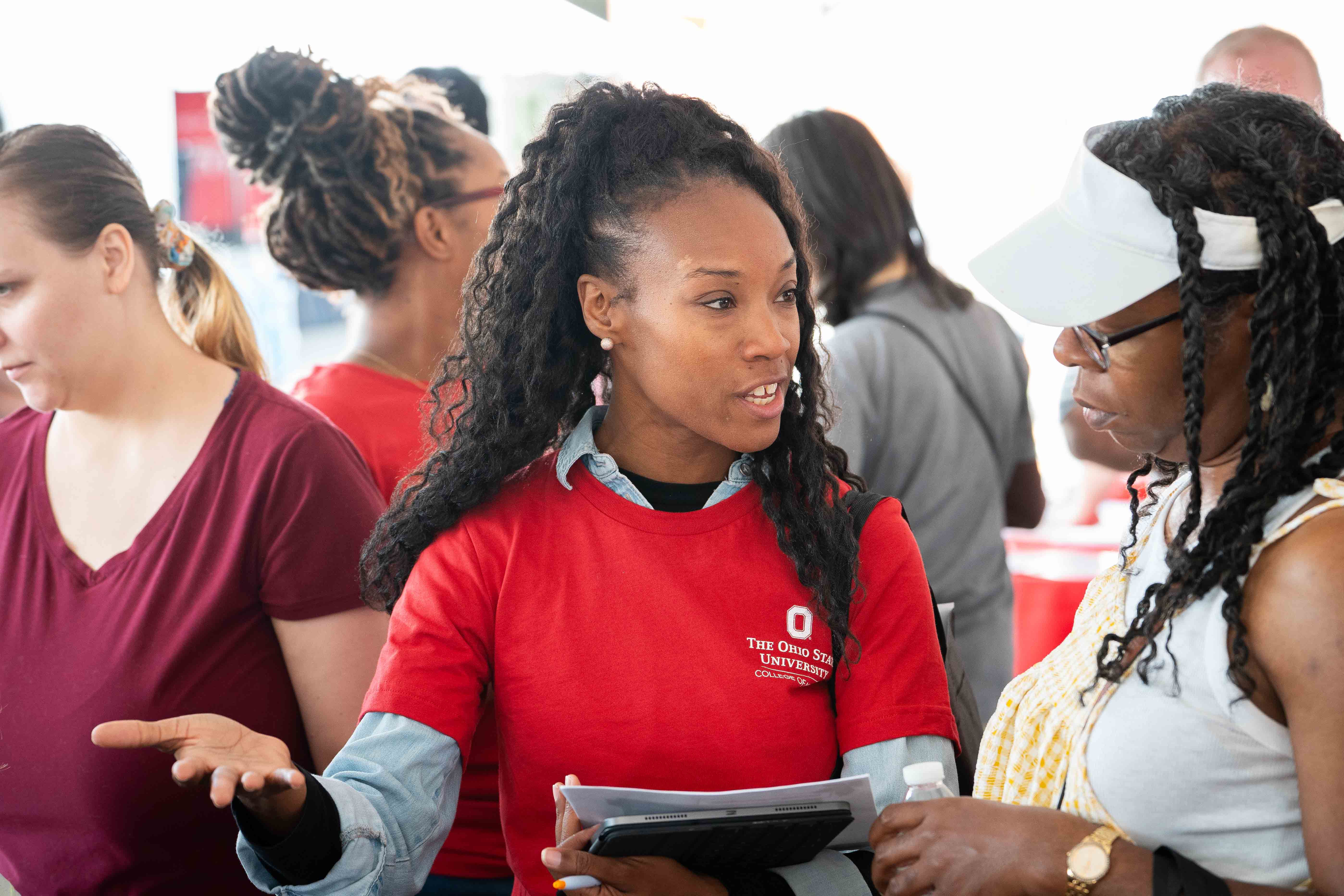 Community Health Worker talking with community members during Healthy Community Day