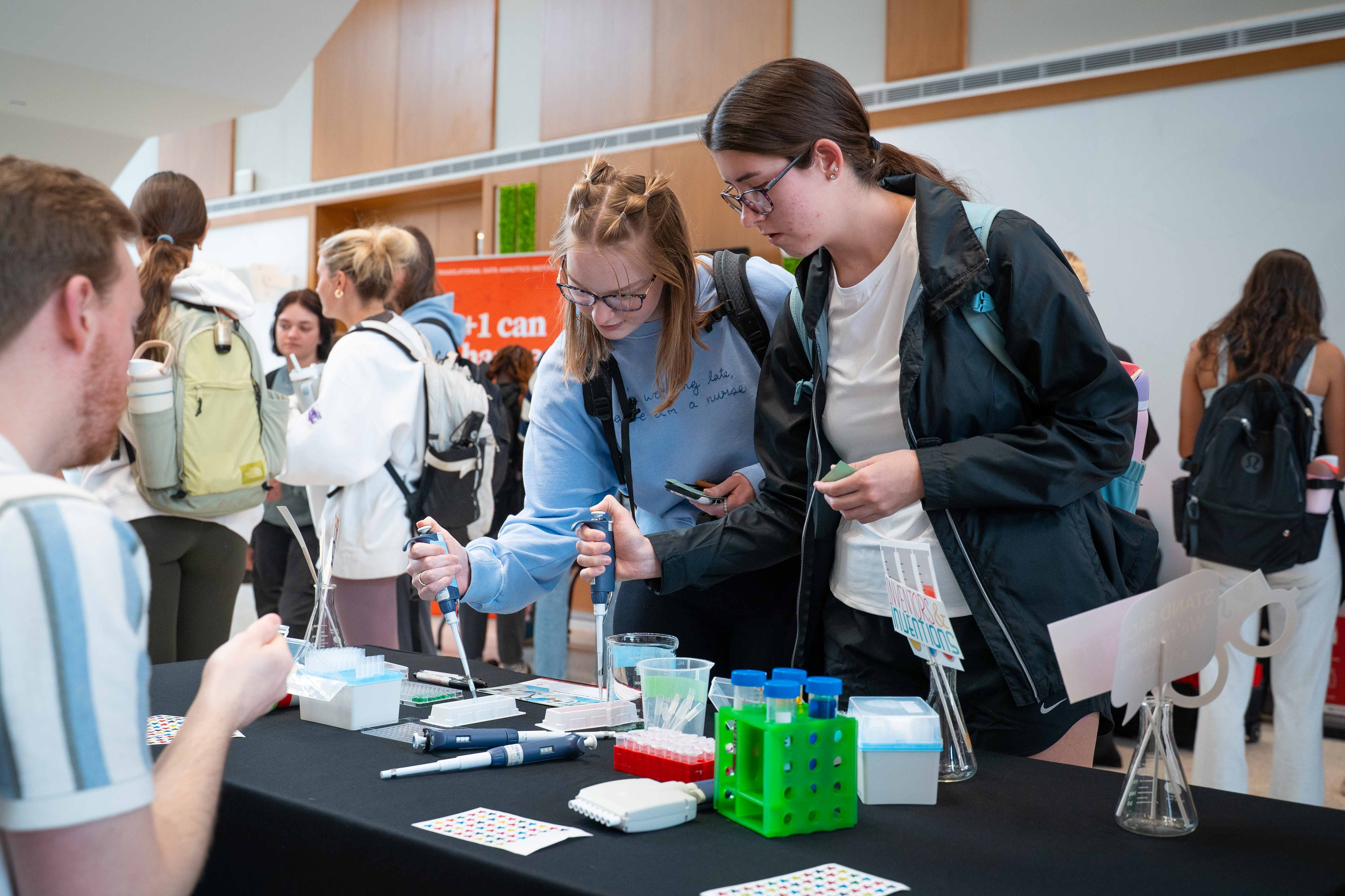 nursing students practice micropipetting at Research Day