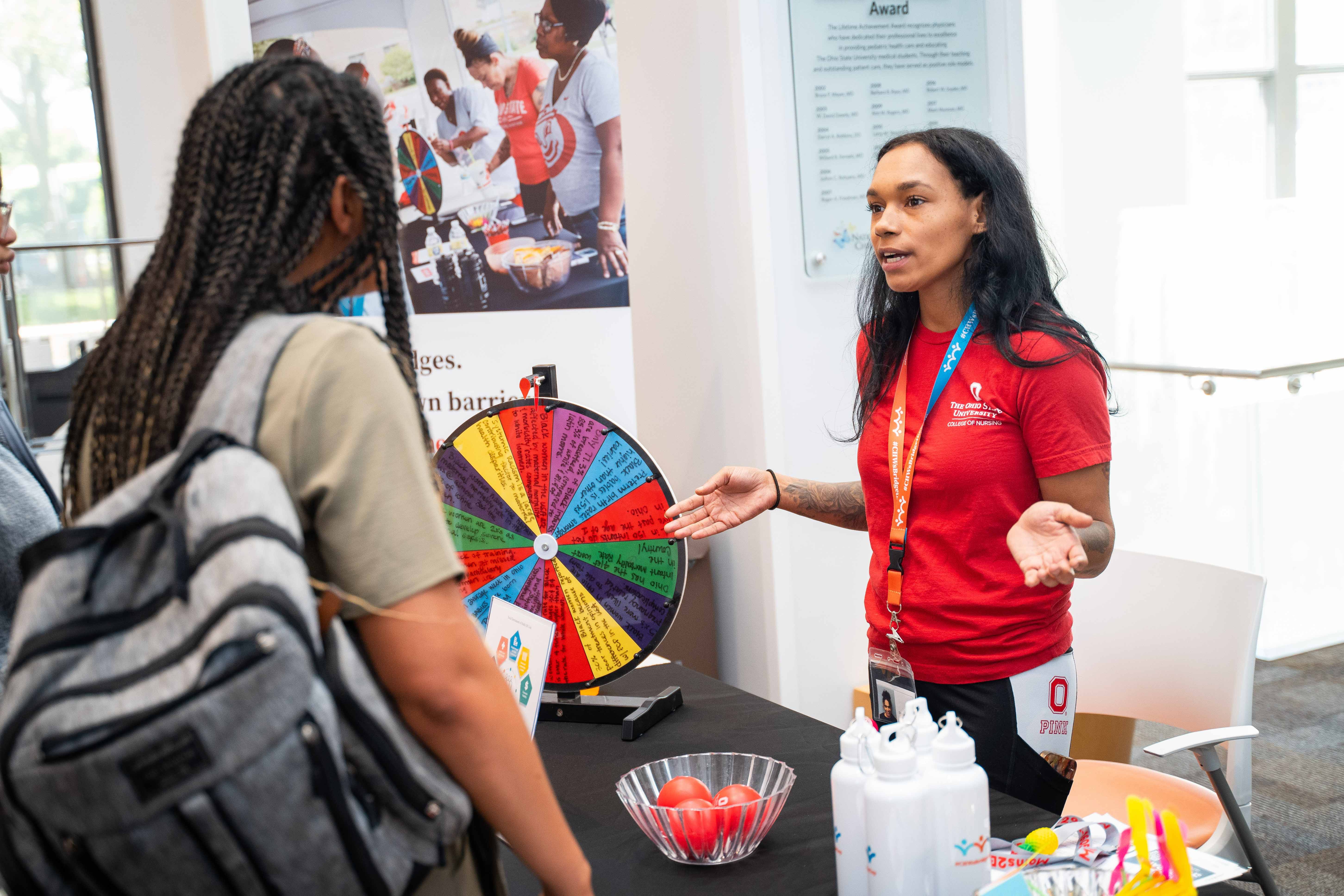Community Health Worker talking with community members during Healthy Community Day