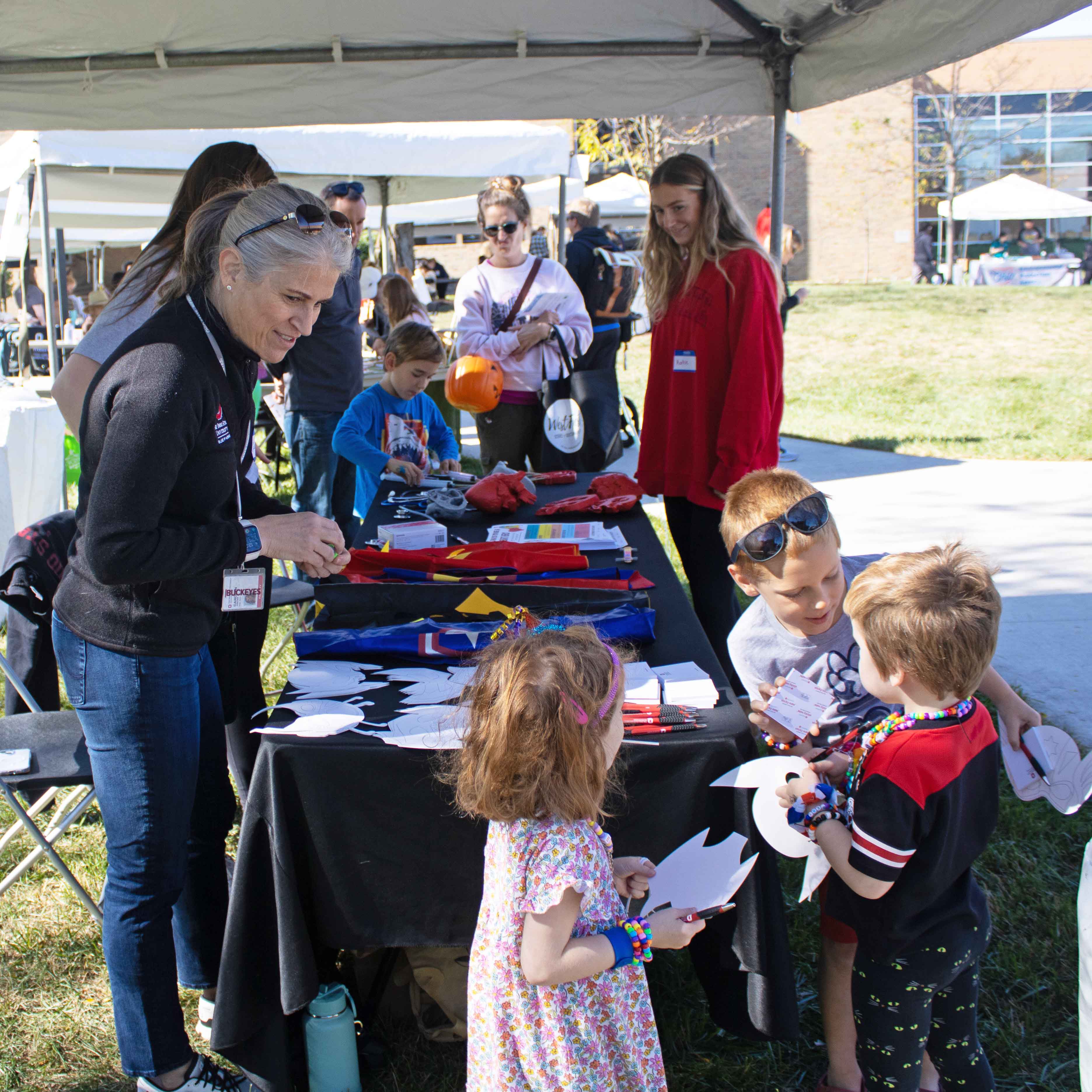 Carolyn Gunther with group of children at community event