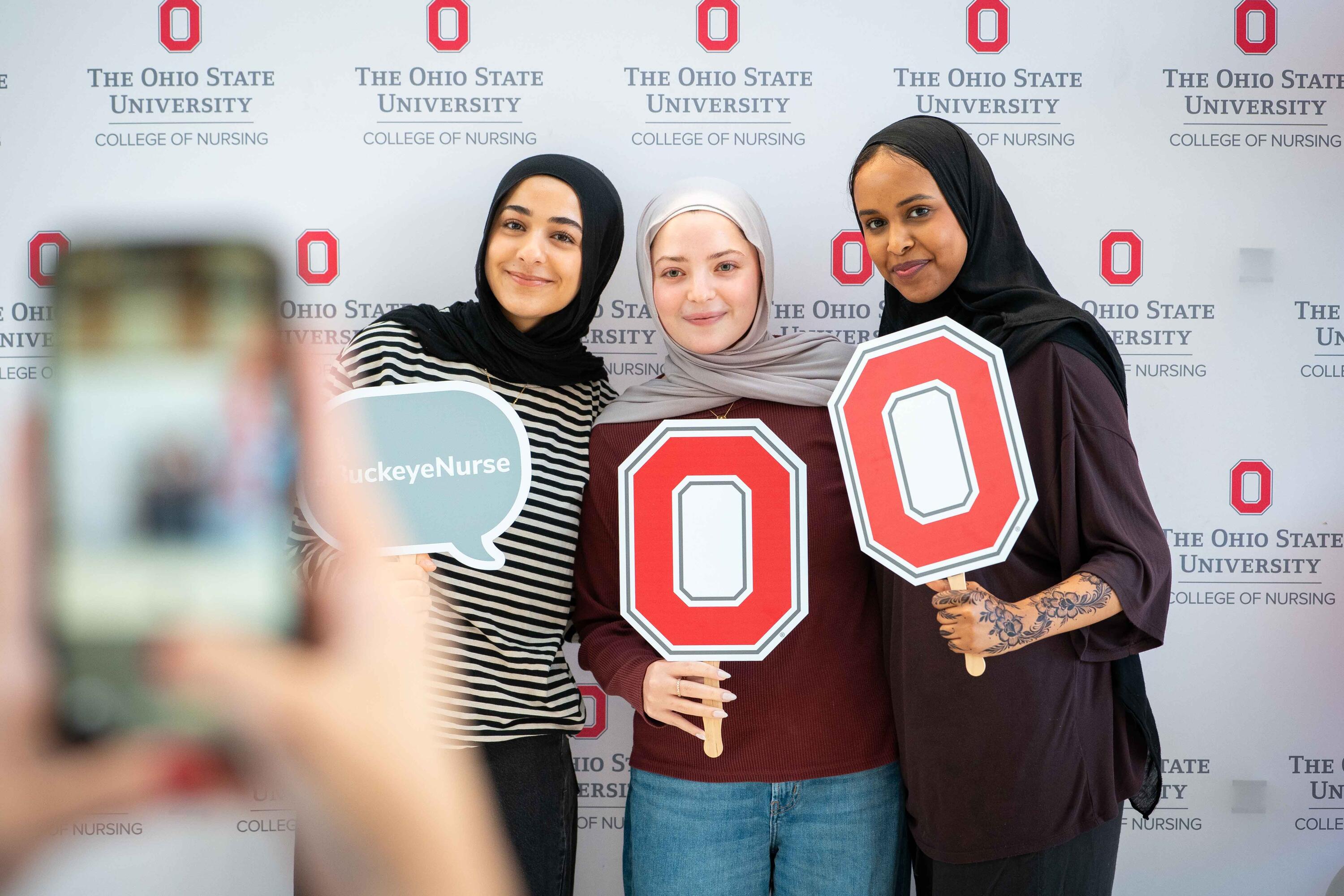 nursing students pose with Ohio State props