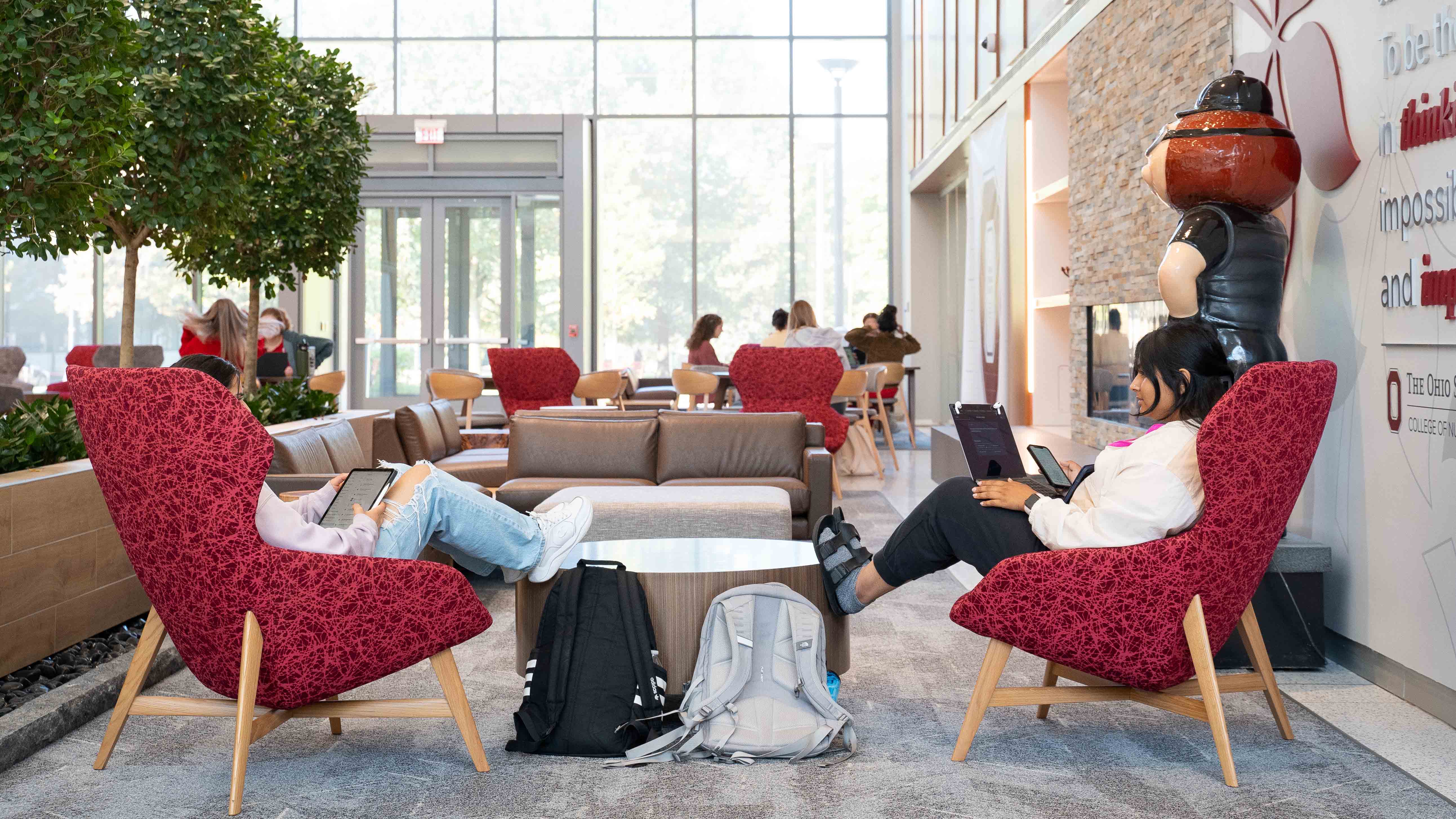 students studying in comfortable scarlet chairs in Heminger Hall atrium