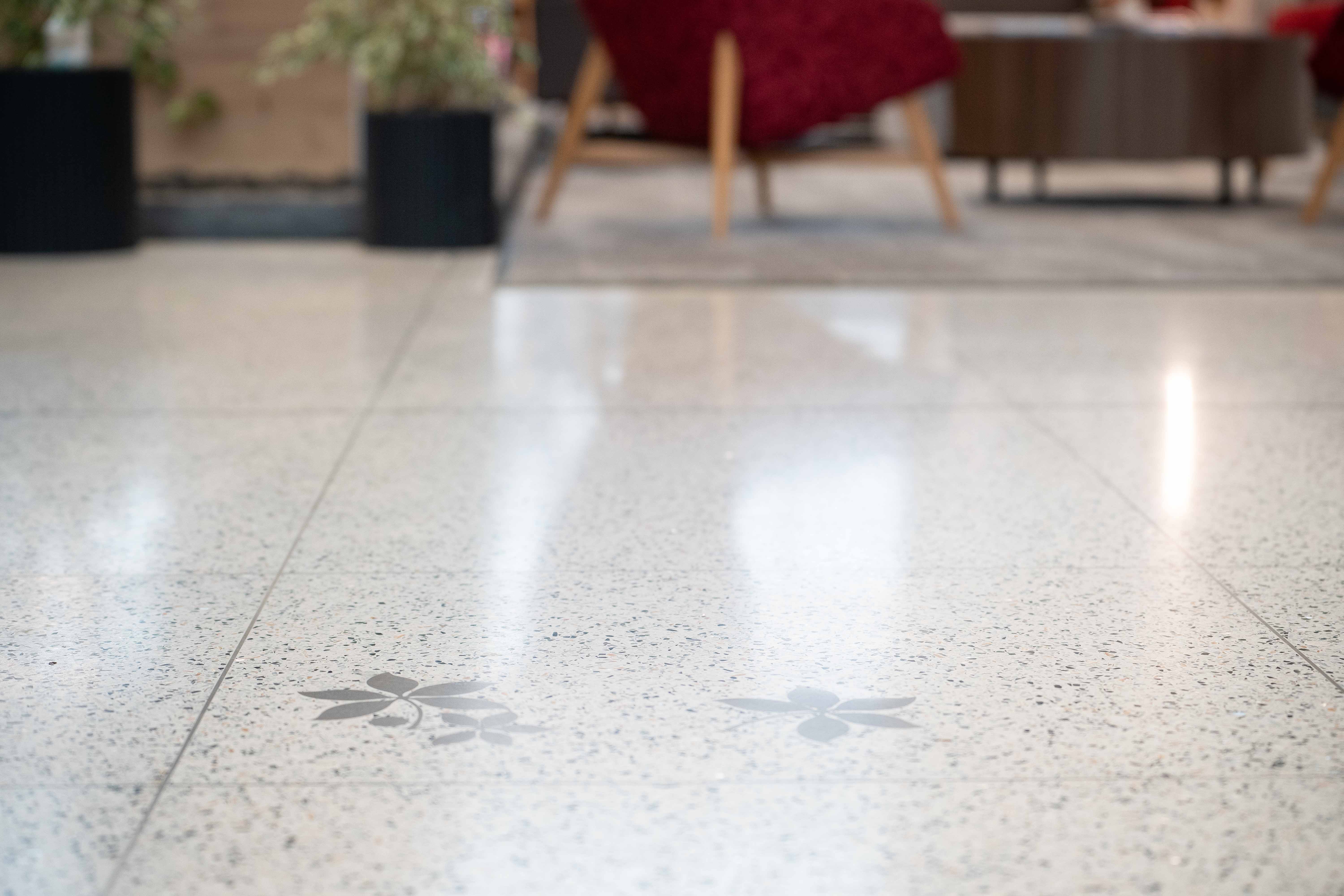 close-up photo of the flooring in Heminger Hall showing inlayed buckeye leaf detail