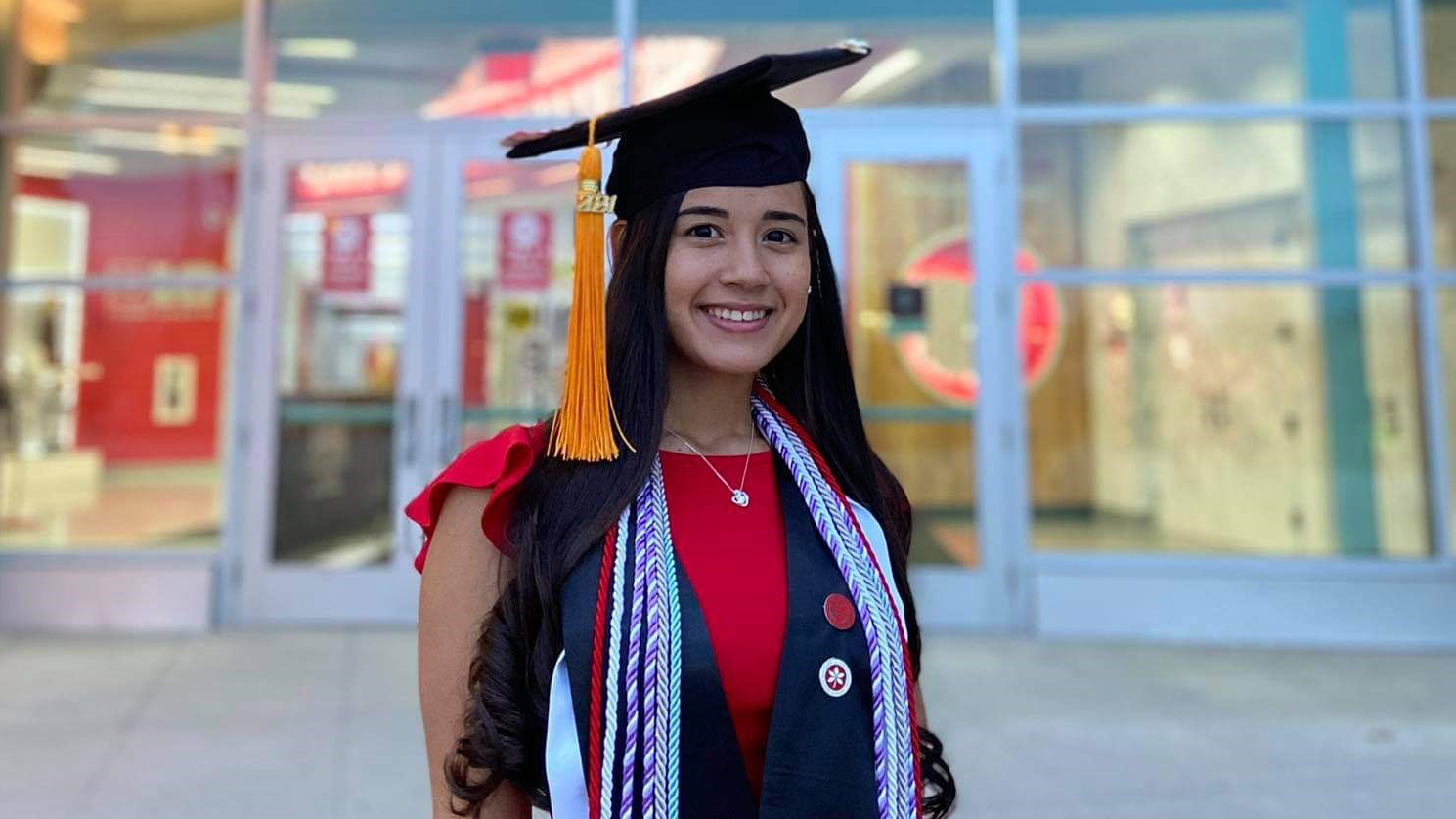 Glorivee Mendez-Mendez wearing her graduation hat and cords