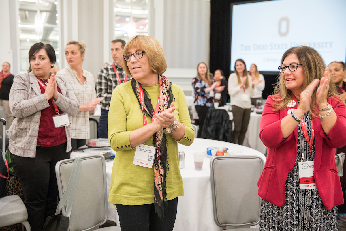 EBP Summit attendees standing and applauding