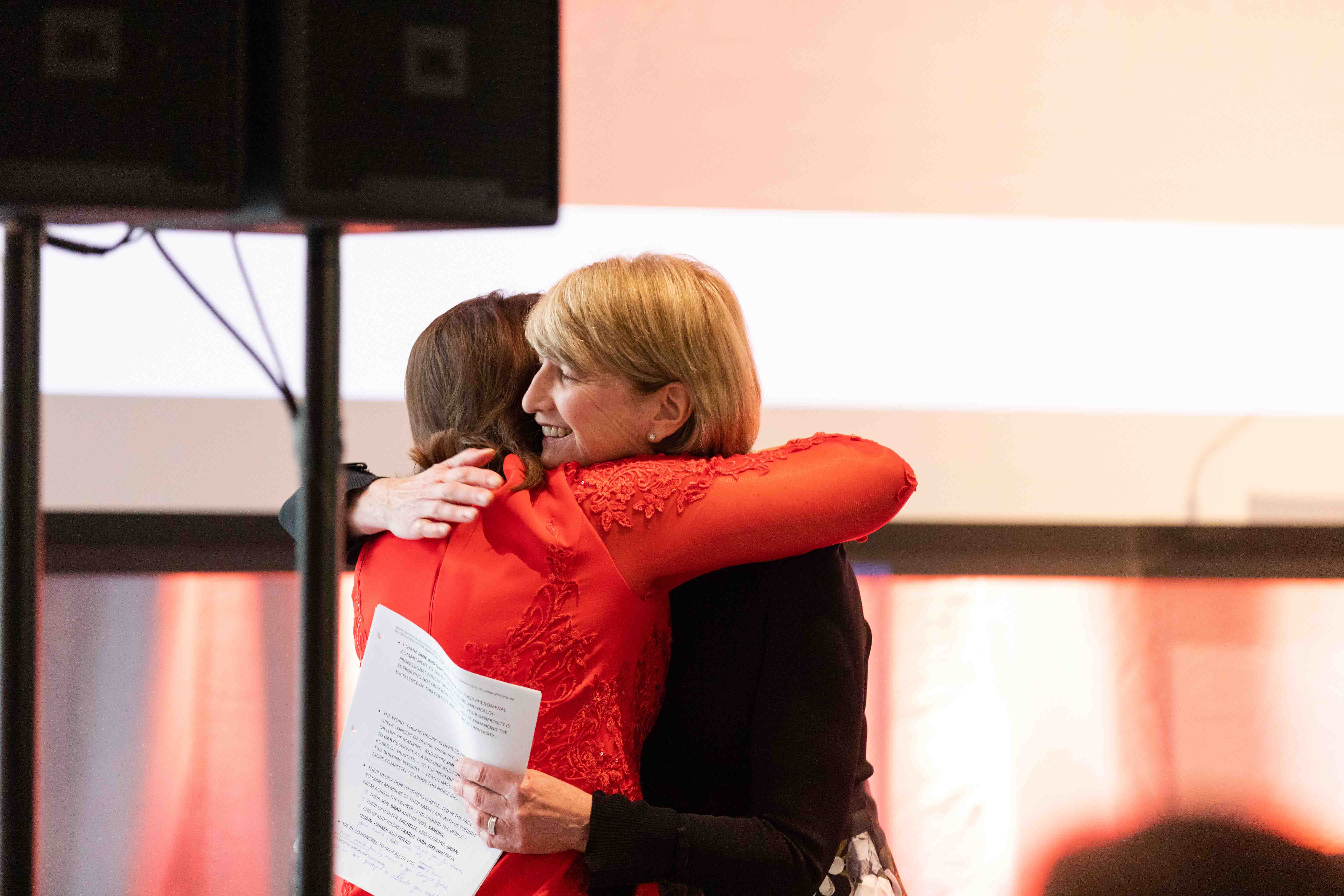 Dean Melnyk and President Kristina M. Johnson embrace at our grand opening gala