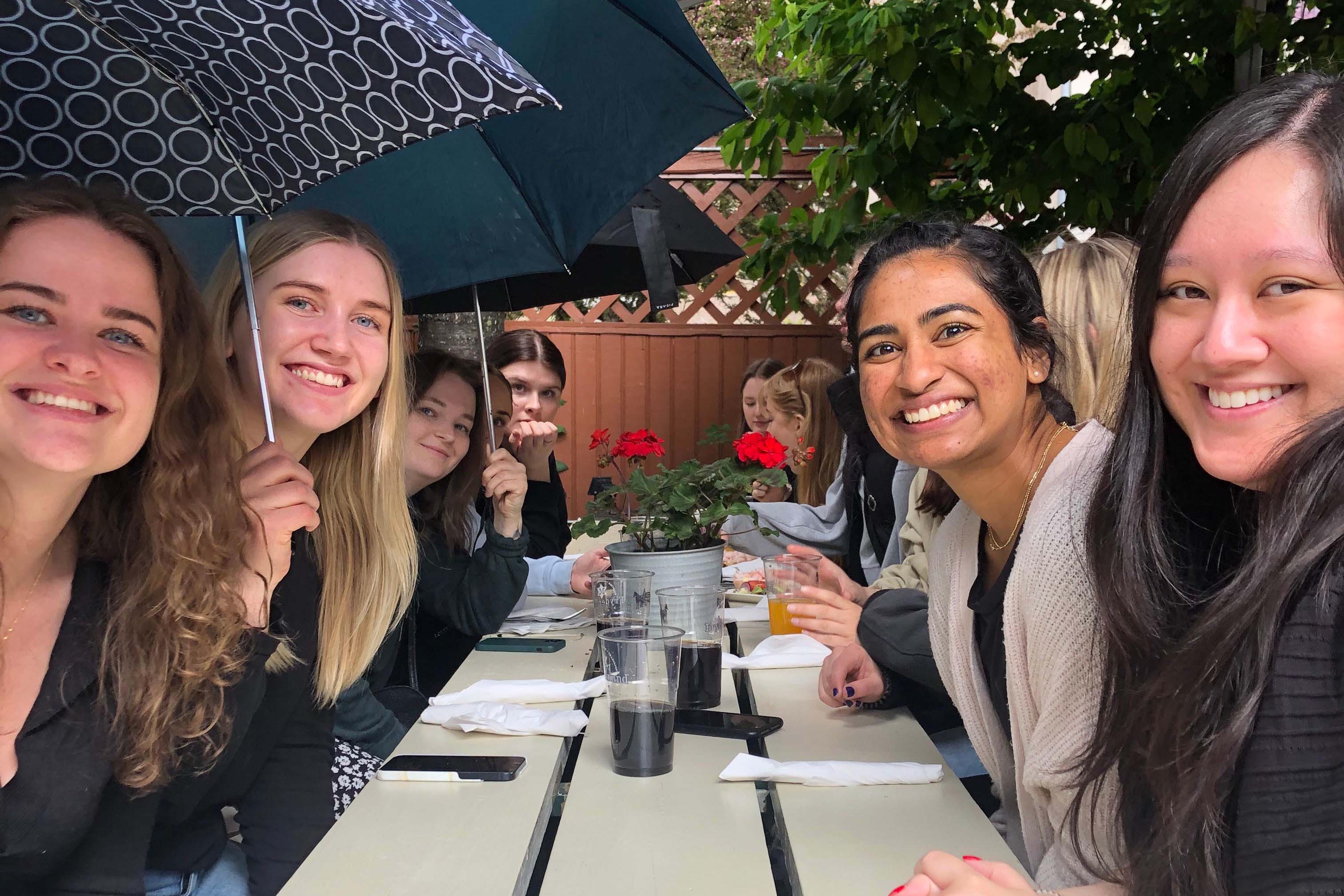 U.S., Norwegian, and Swedish students collaborating at a lunch meeting in the rain