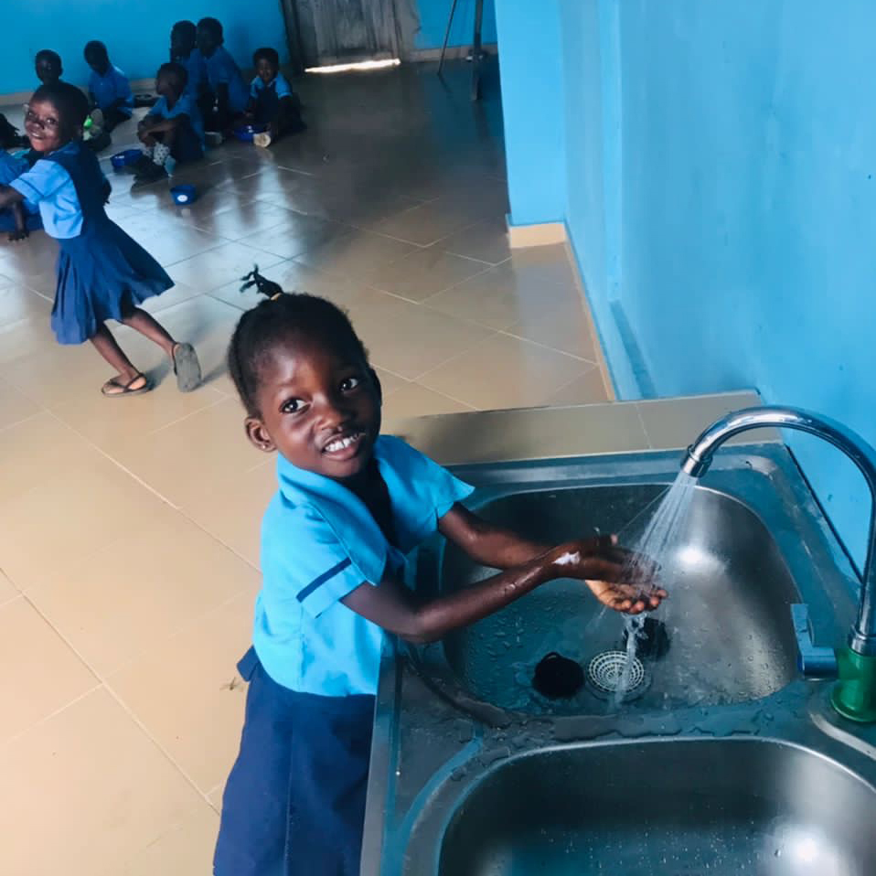 young girl washing her hands