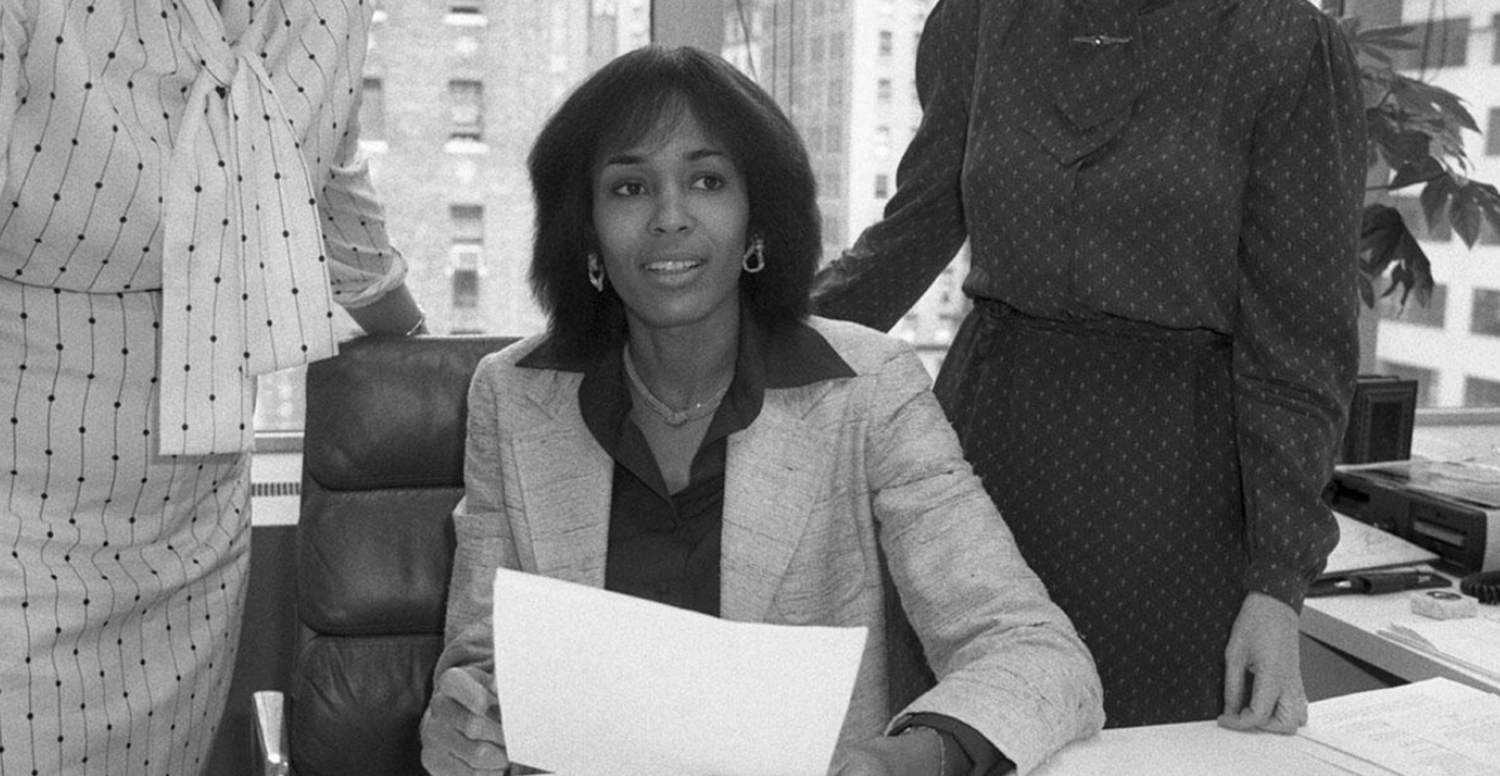 black and white photo of Faye Wattleton sitting at a desk