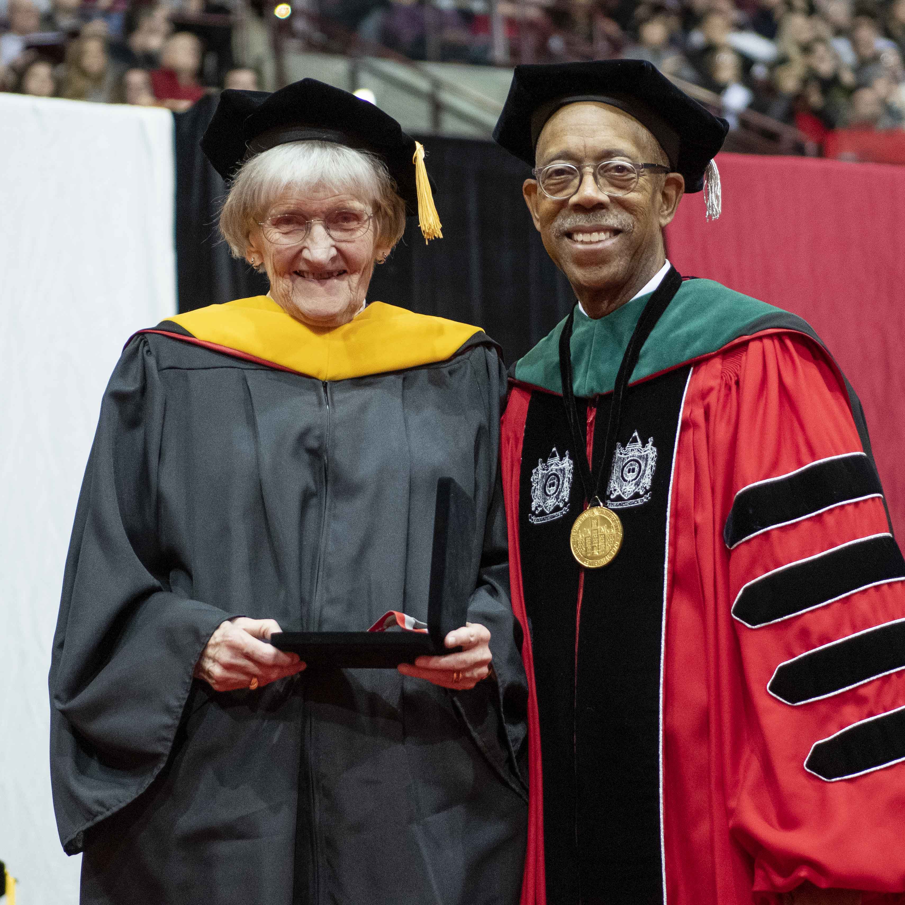 Kitty Kisker receiving the Distinguished Service Award from President Michael V. Drake