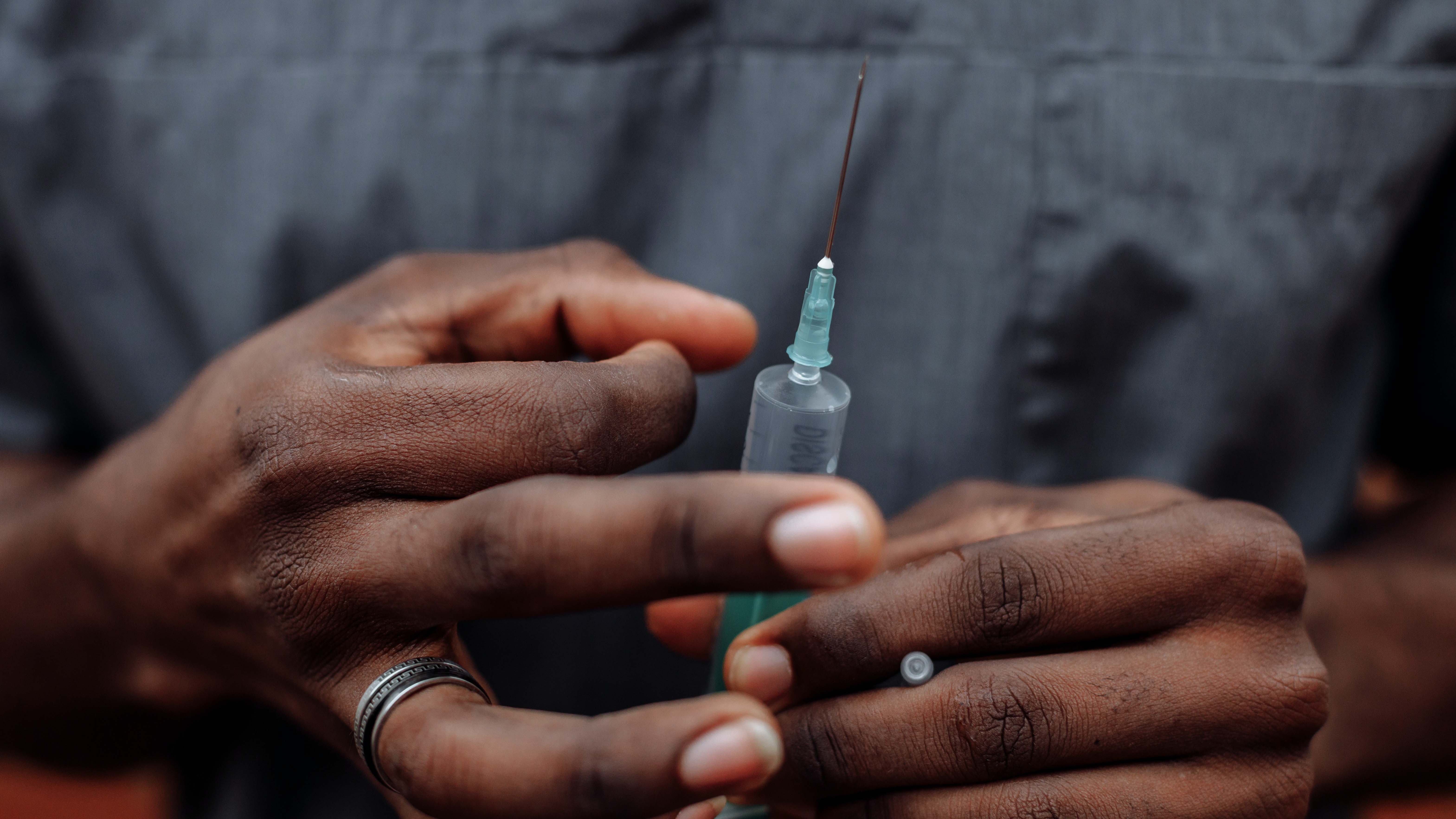 African American man flicking a needle