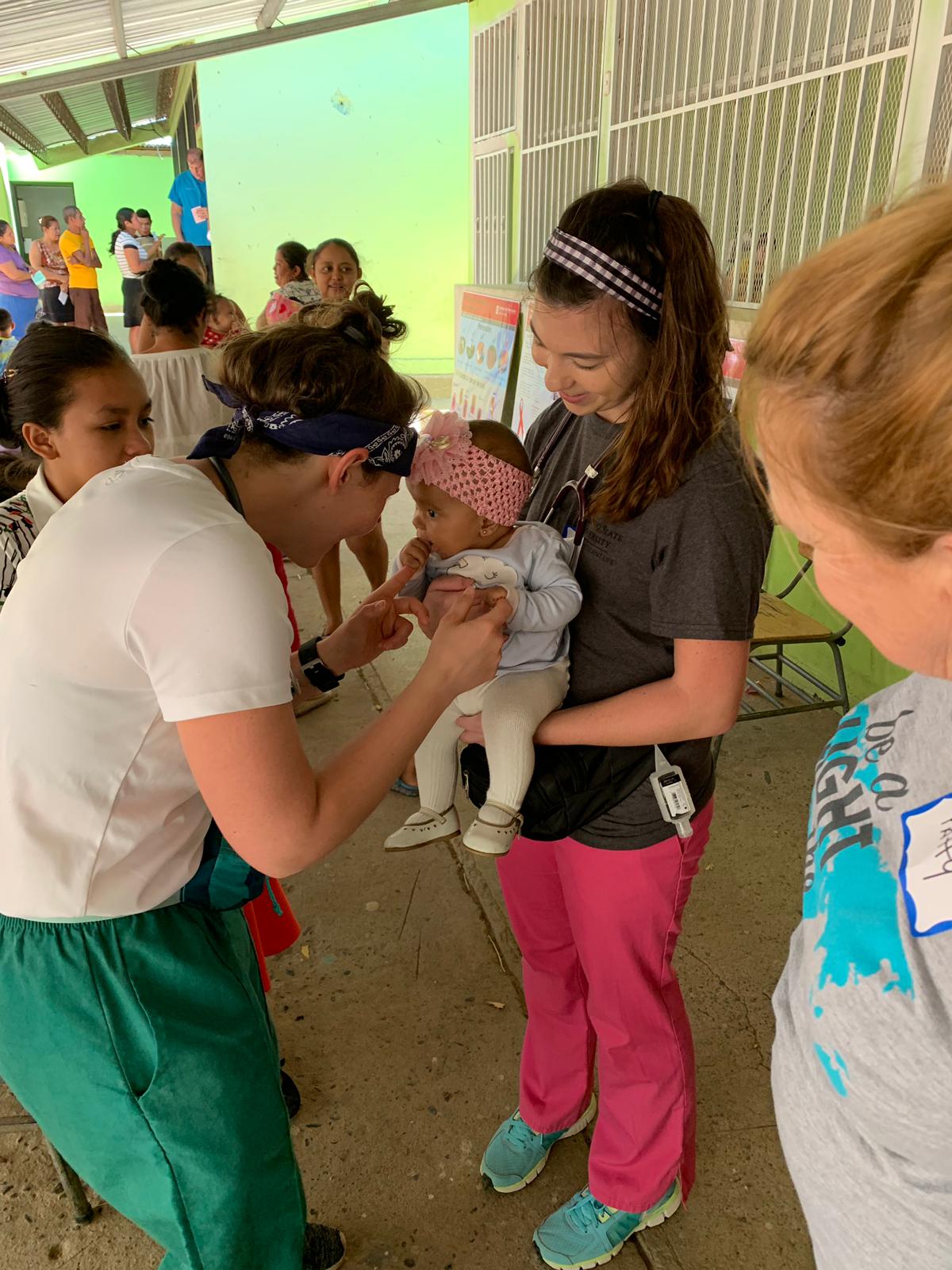 nursing student with baby