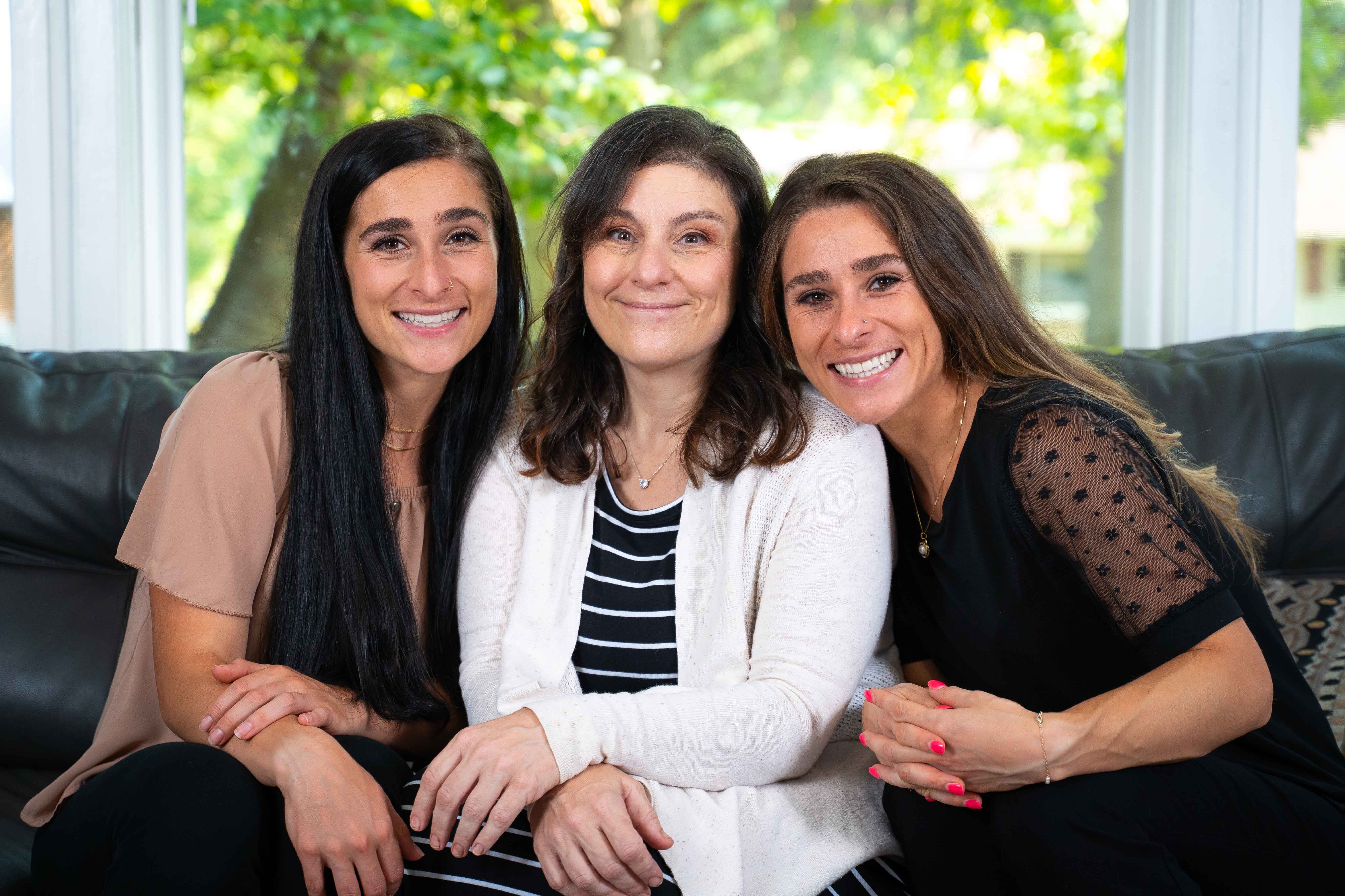 Ariel, Kareen and Raven pose on the couch at Kareen’s house