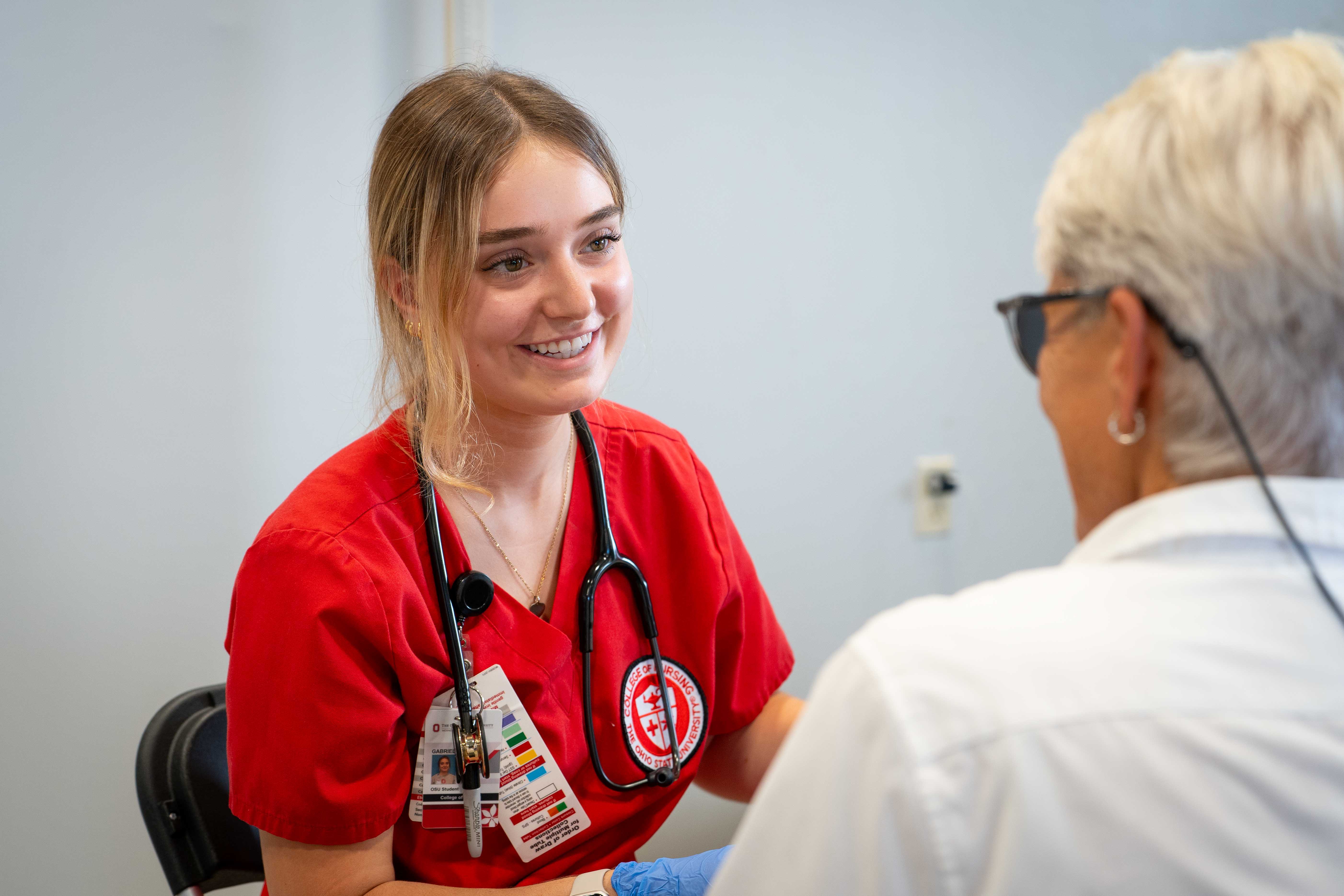 Gabriella Gustitus interacting with a Farm Science Review attendee.