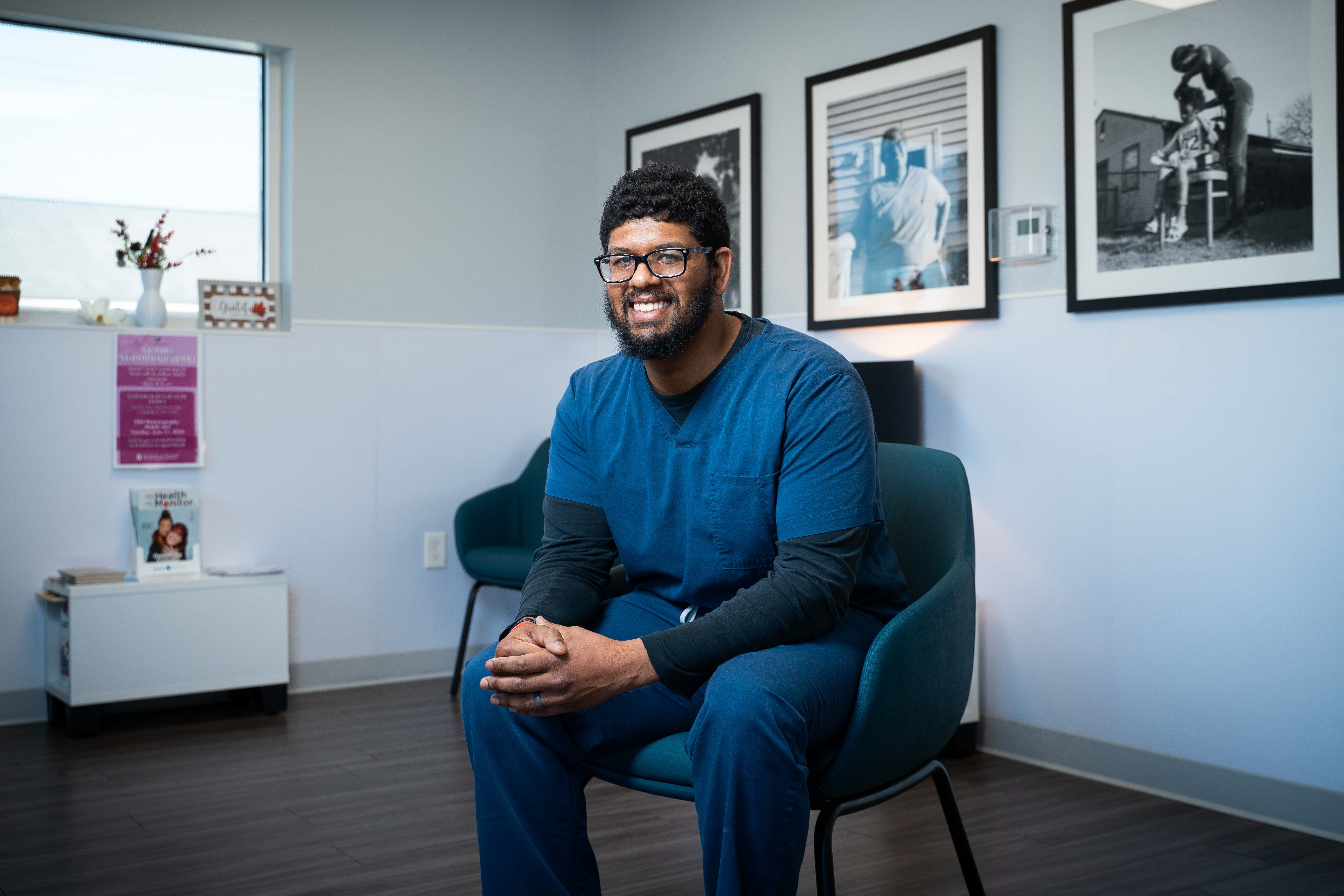 Jordan Singh sitting on a chair in the clinic's waiting room