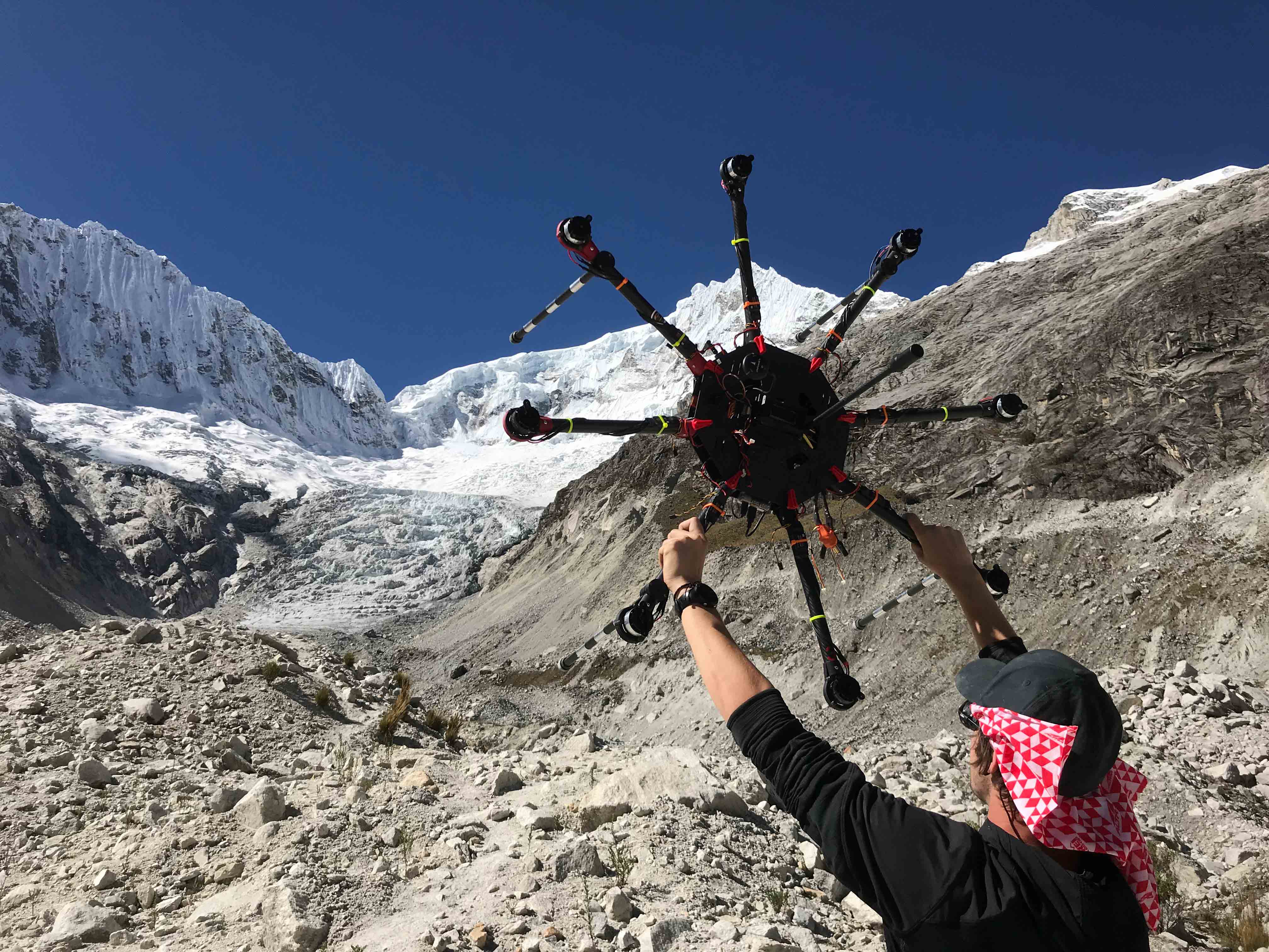 man holding drone in the mountains
