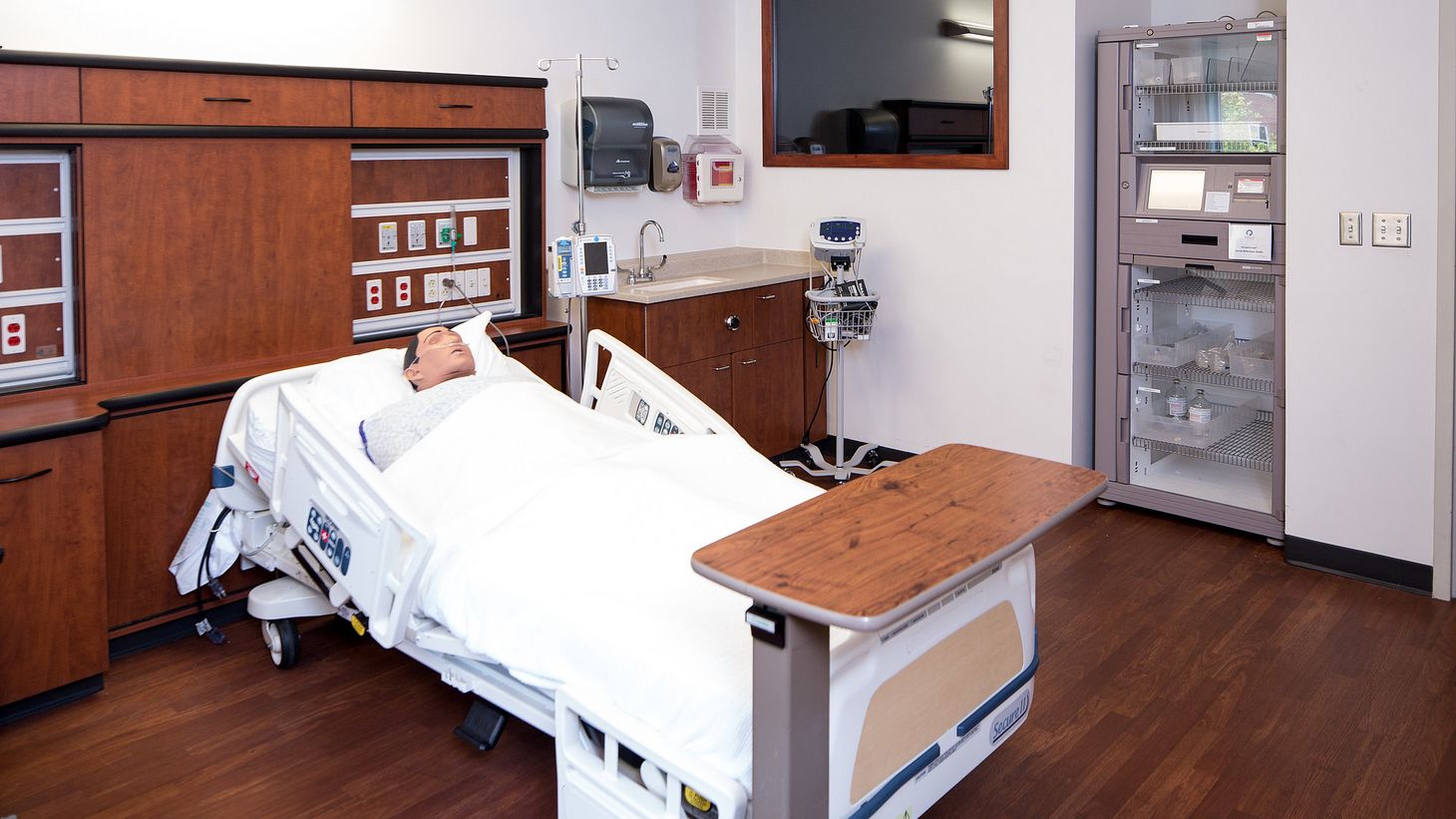 hospital simulation room with human simulator in patient bed