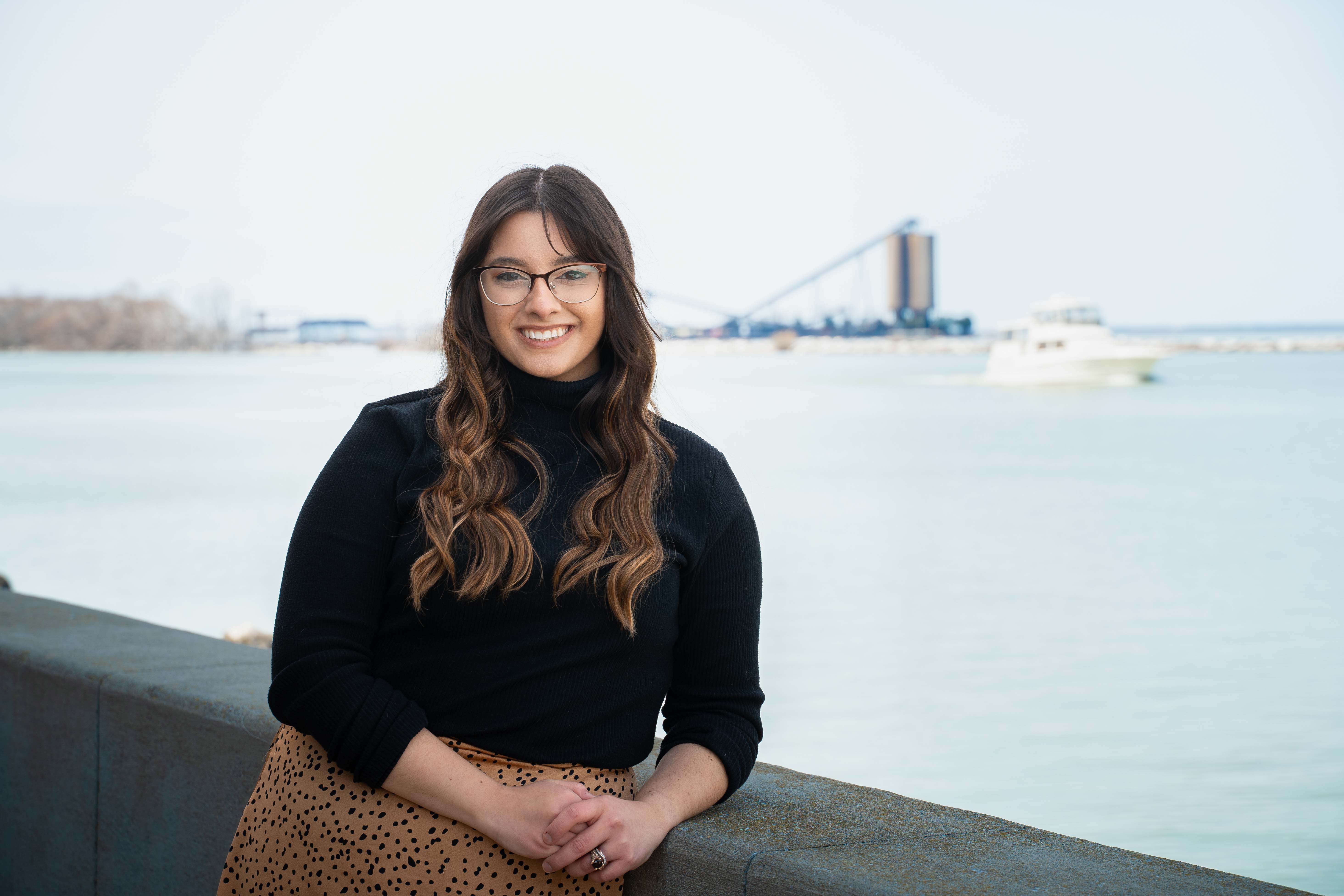 Maddy Davies posing beside Lake Erie