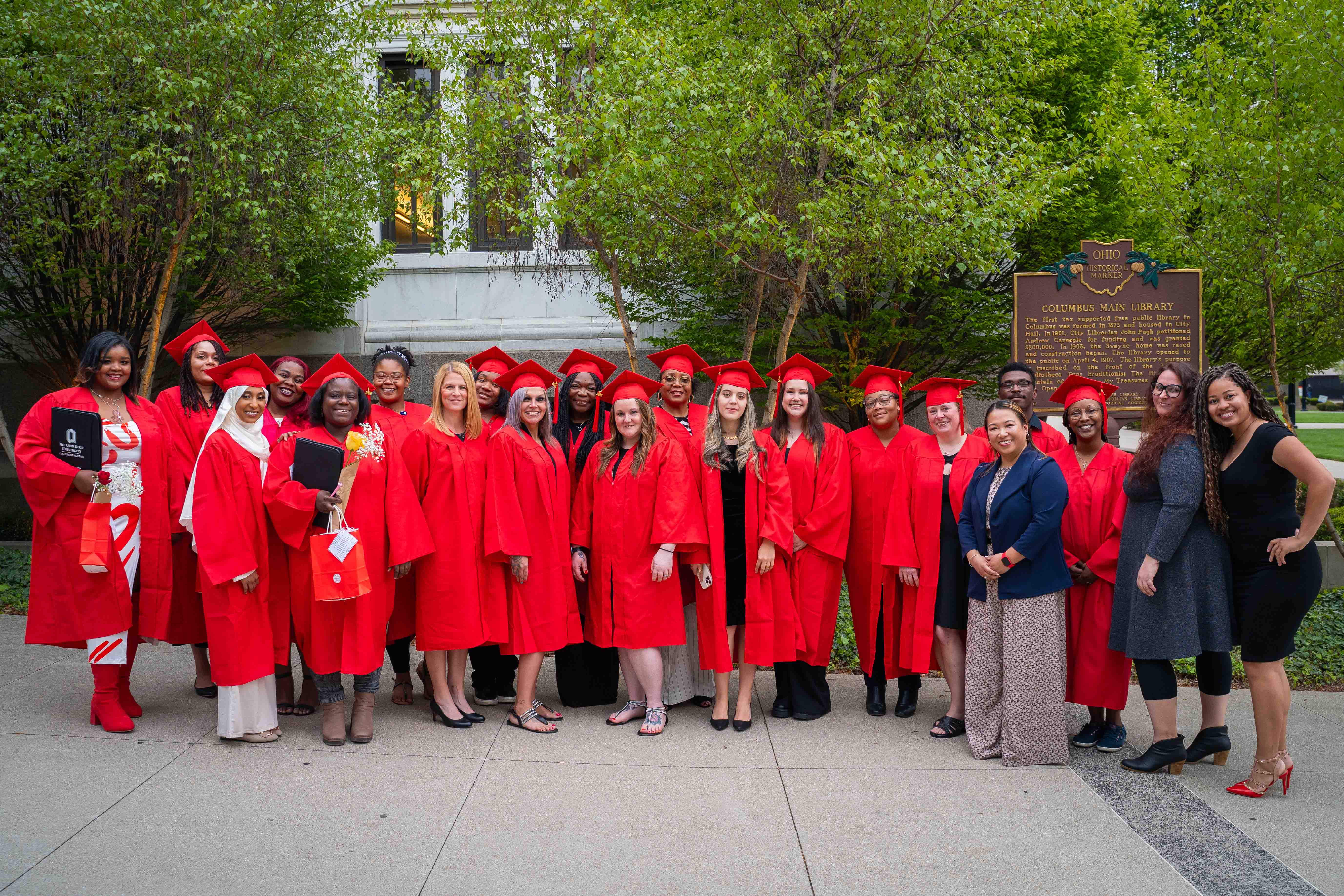 Group of graduates in red caps and gowns