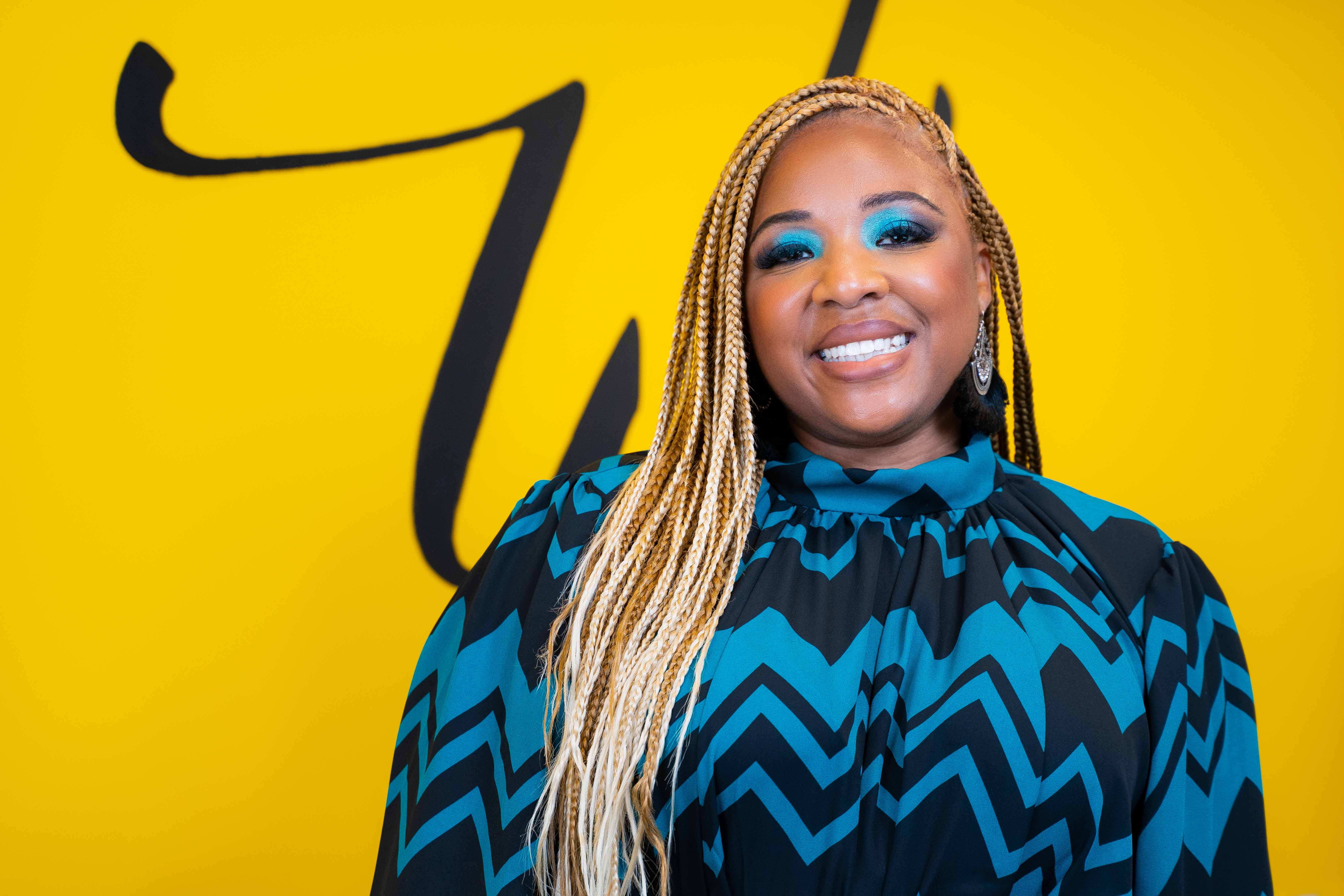 Da'na Langford in front of a bright yellow wall