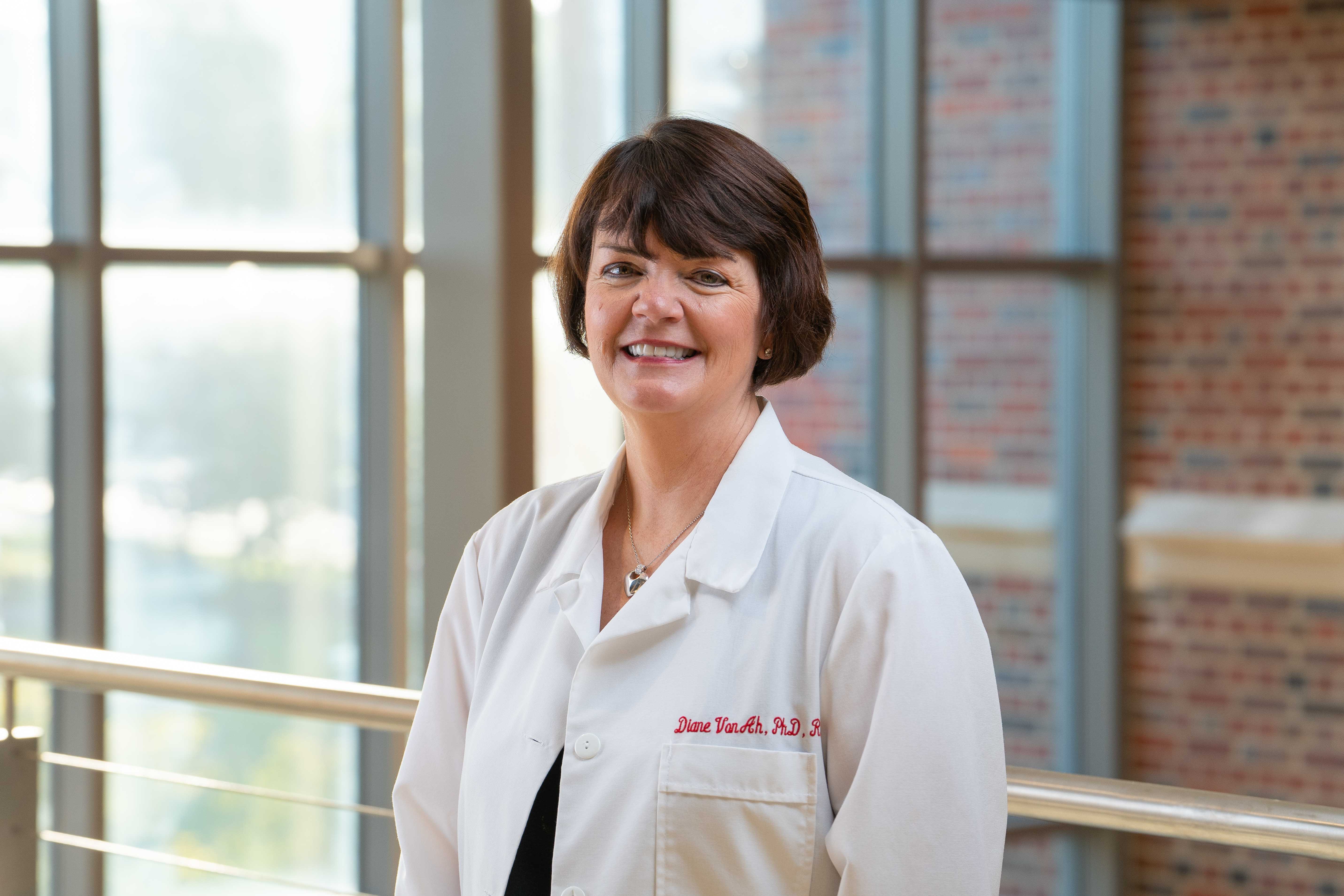 Diane Von Ah wearing a white lab coat