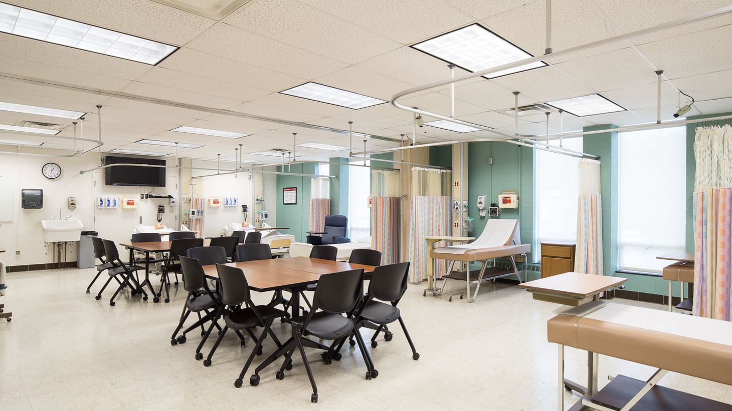 simulation room with patient beds and tables for collaboration