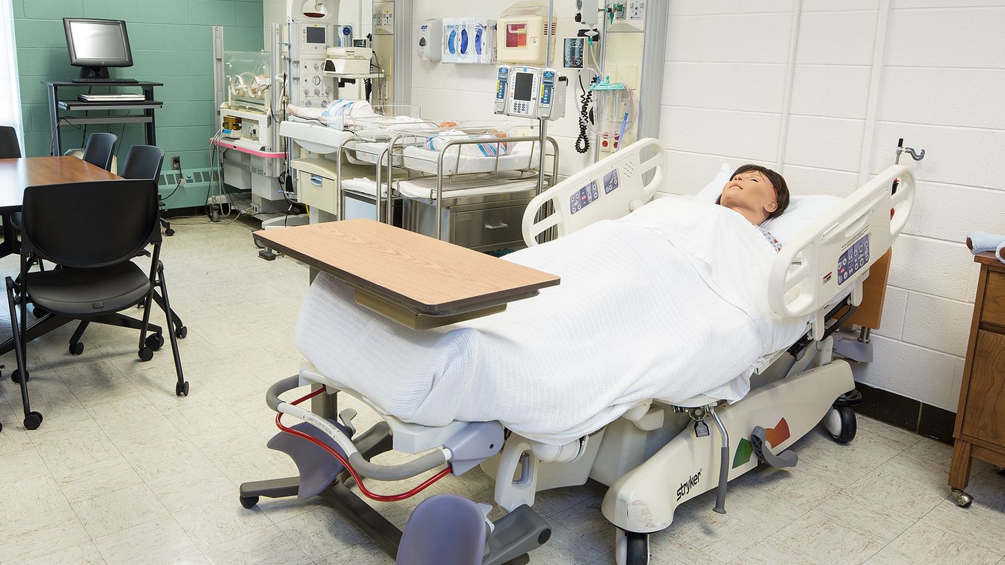 hospital simulation room with human simulator in patient bed