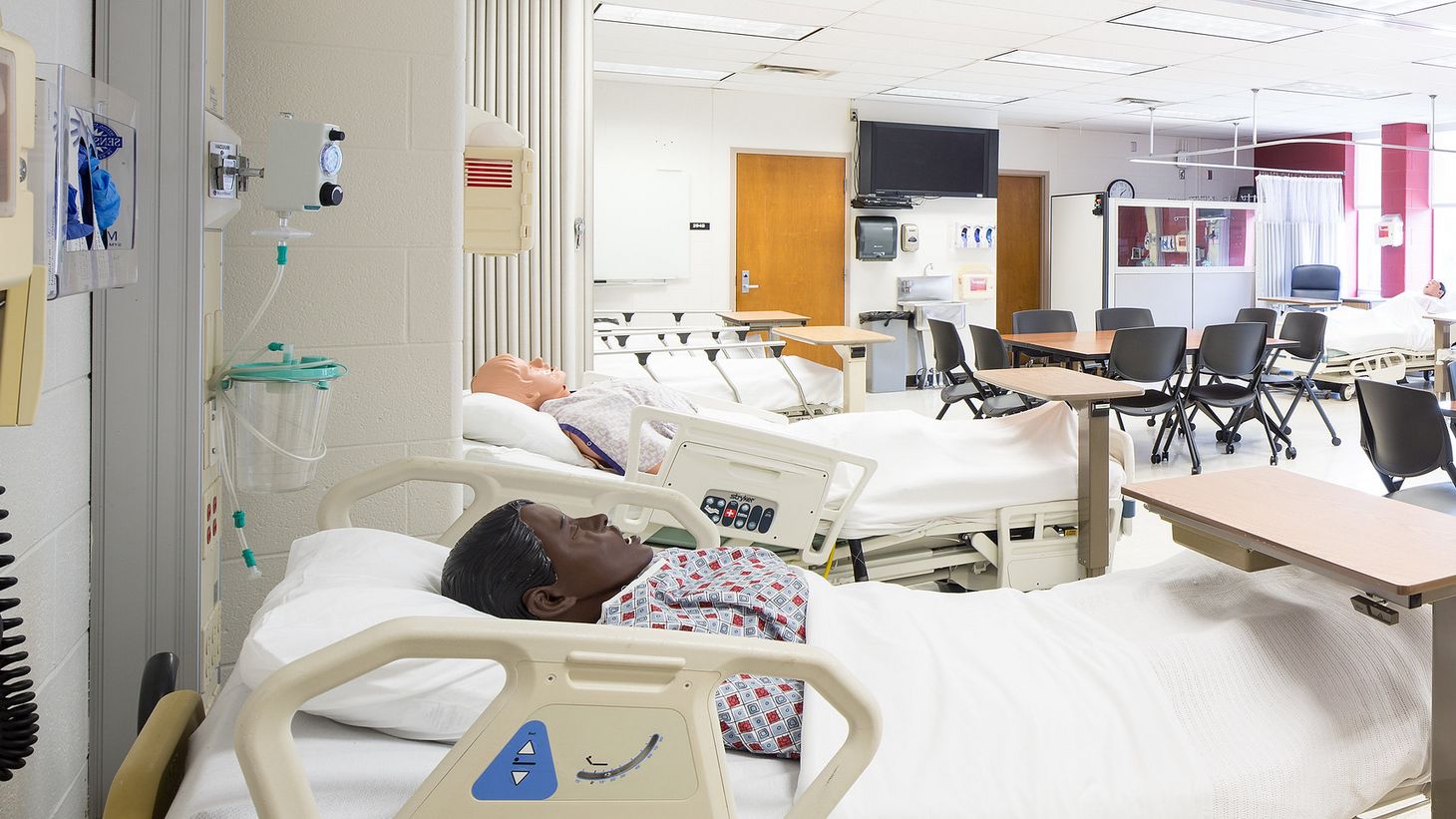 hospital simulation room with human simulator in patient bed