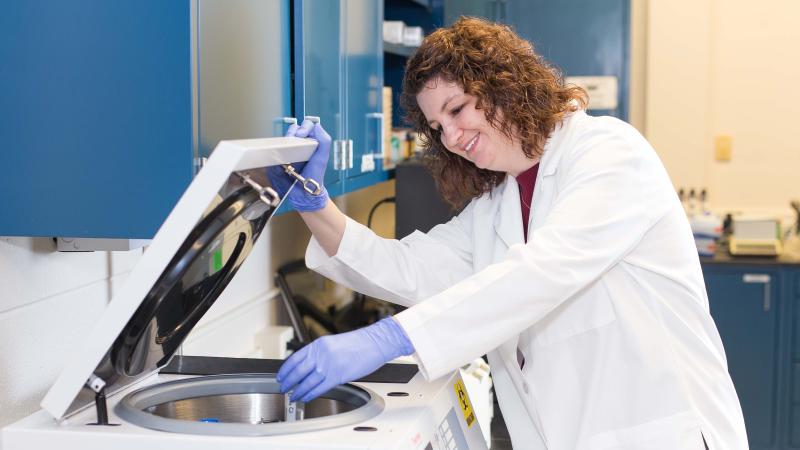 PhD candidate in the lab conducting research