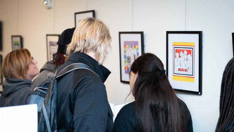 Two students standing in front of artwork