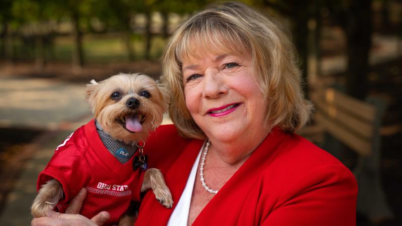 Linda Connor with her dog in an Ohio State jersey