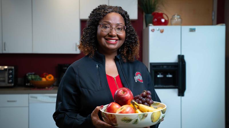 Kathy Wright holding a bowl of fruit