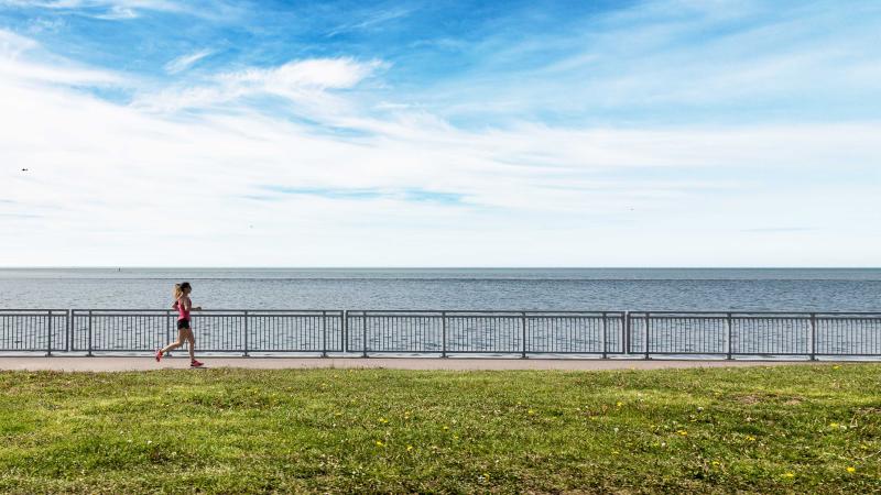 woman running on a path by a lake