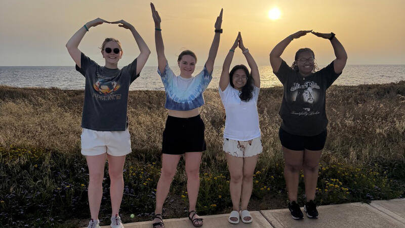 Four students spelling out OHIO with their arms