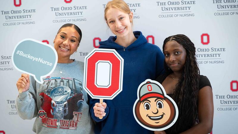nursing students pose with Ohio State props
