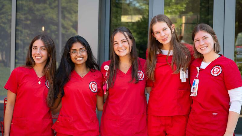 BSN students in red scrubs