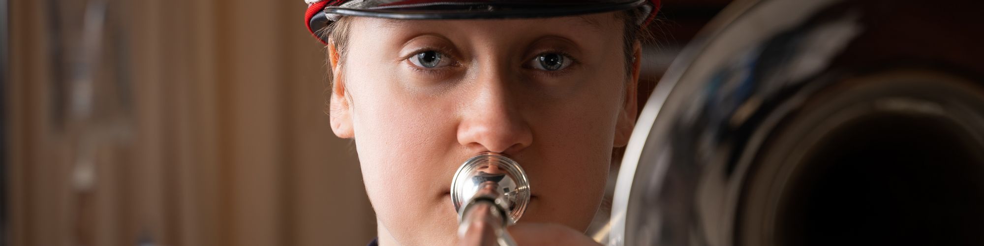nursing student with trombone in marching band attire