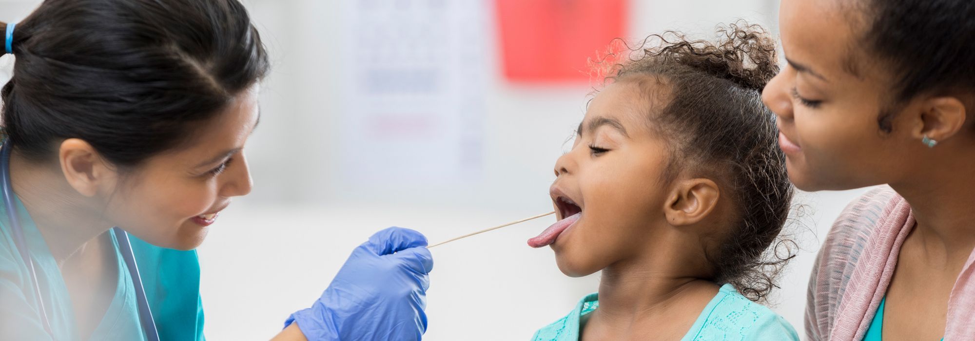 Nurse looking inside a child's mouth