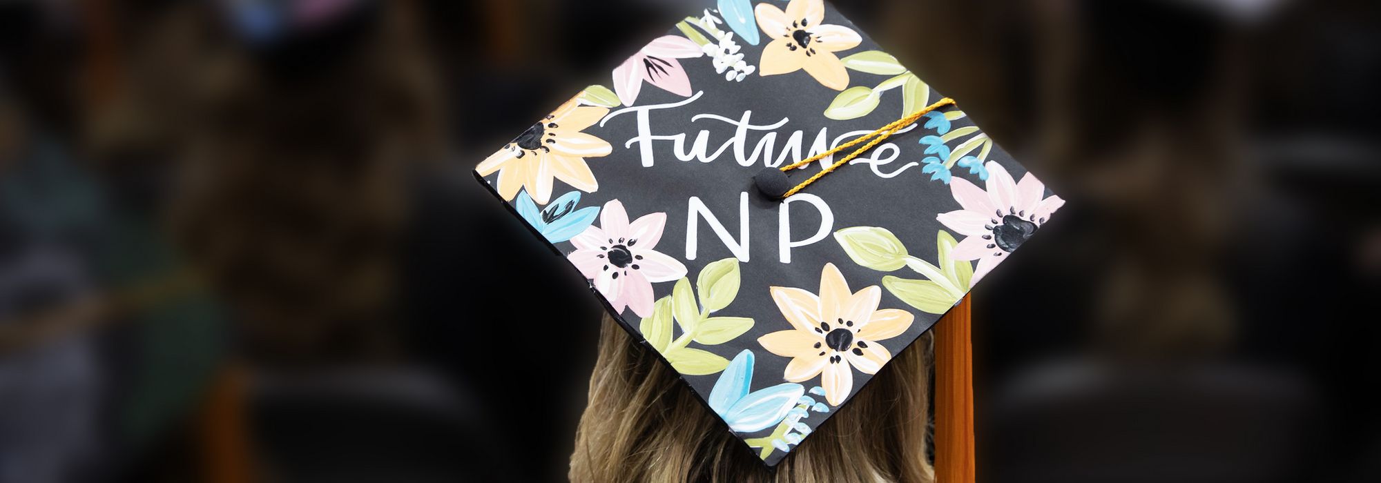 graduation cap that reads "Future NP" with a painted flower border