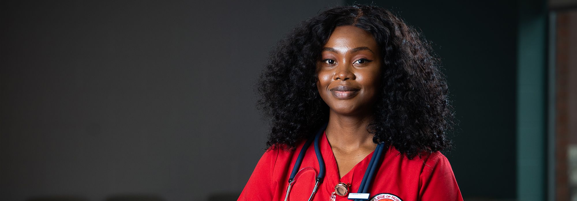 Fran Osei Wusu, BSN student in red scrubs