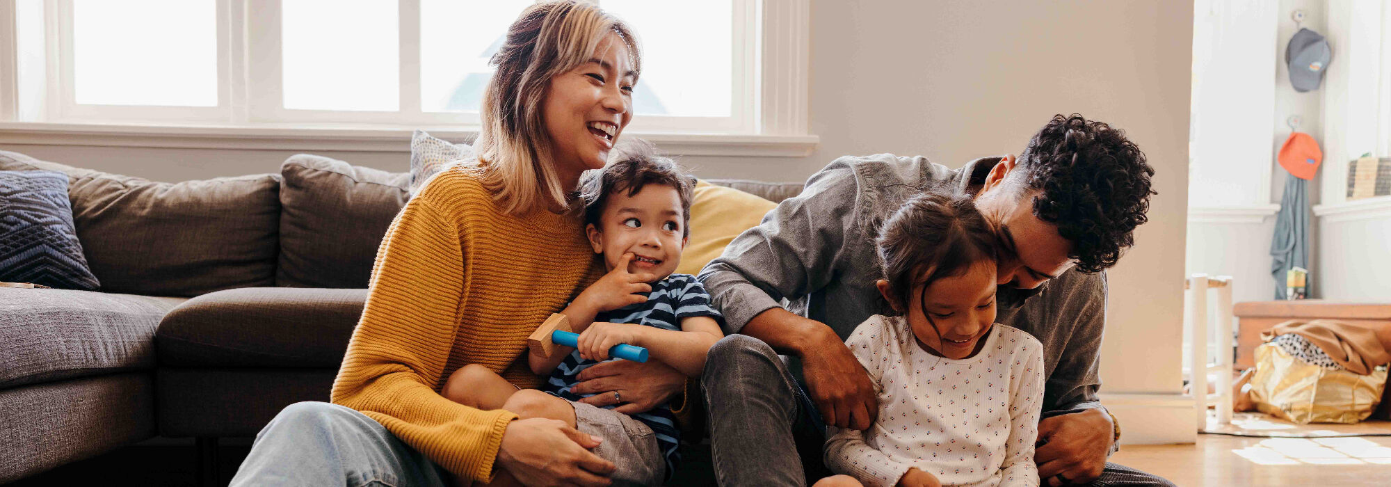 Young parents having fun with their children at home
