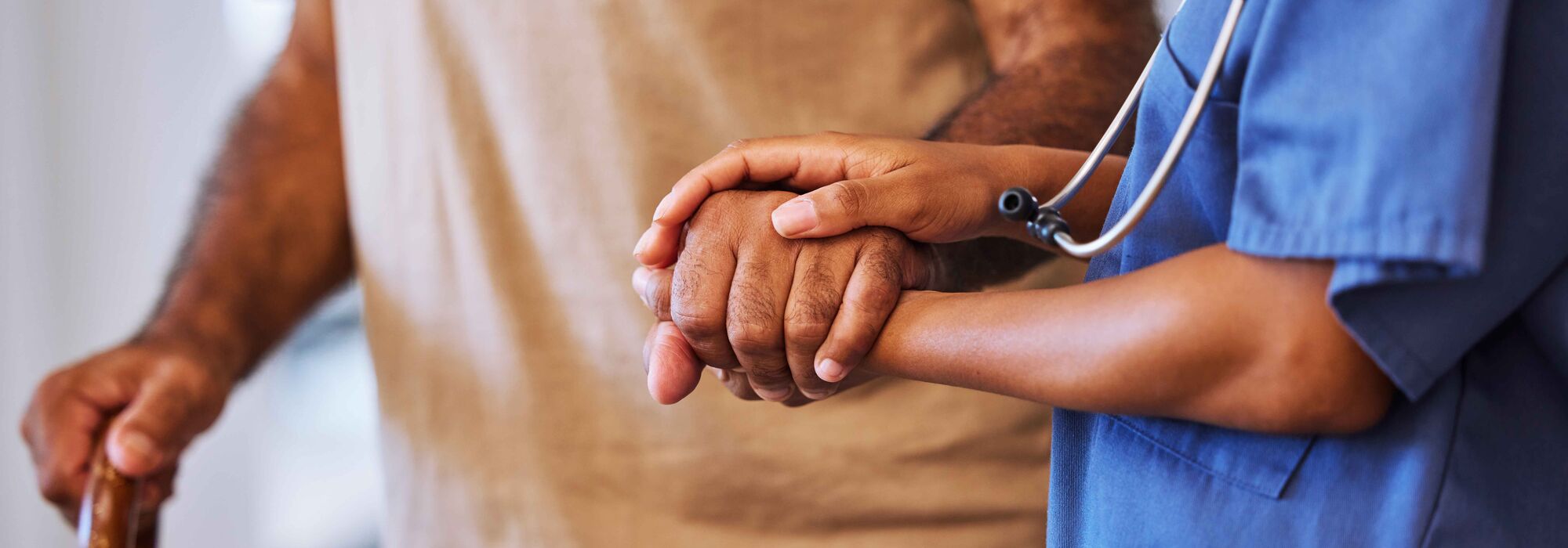 healthcare provider holding the hand of a patient