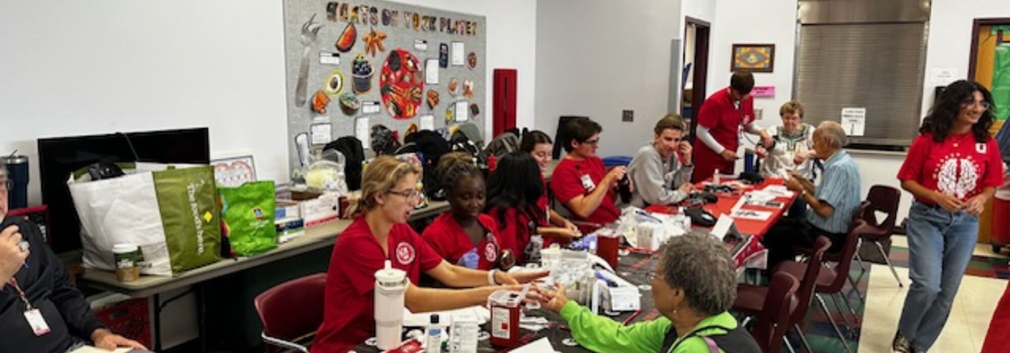 Ohio State nursing students providing health screenings including blood pressure and glucose monitoring.