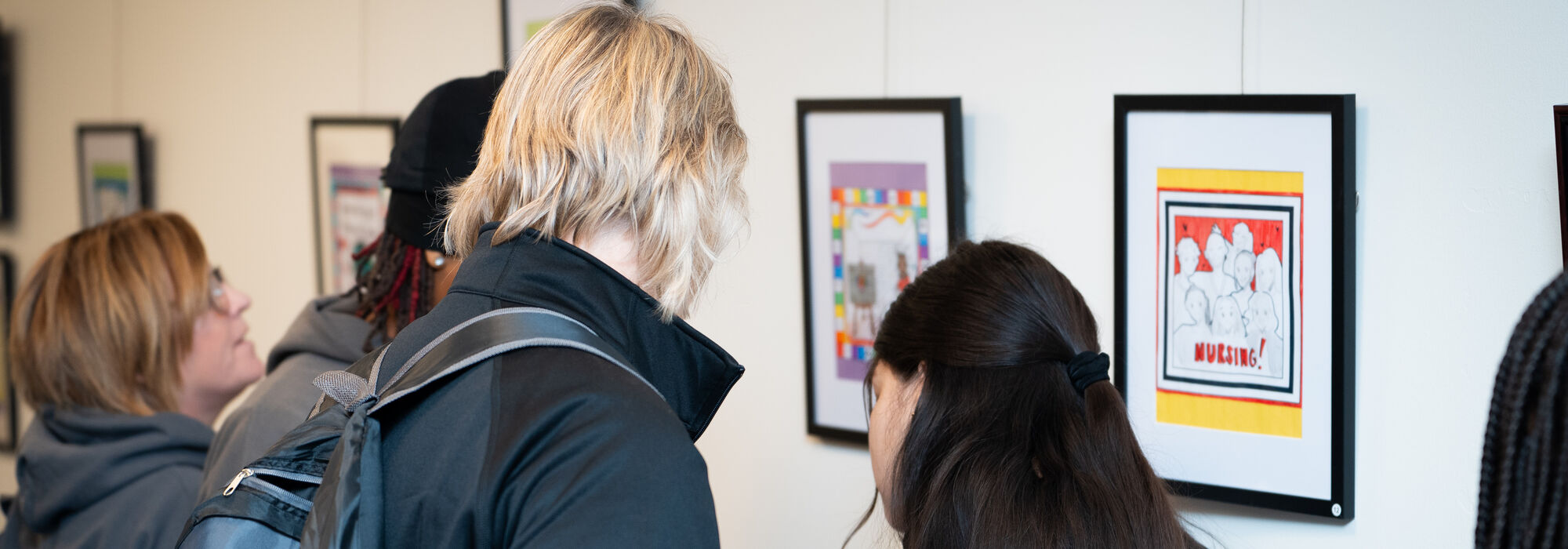 Two students standing in front of artwork